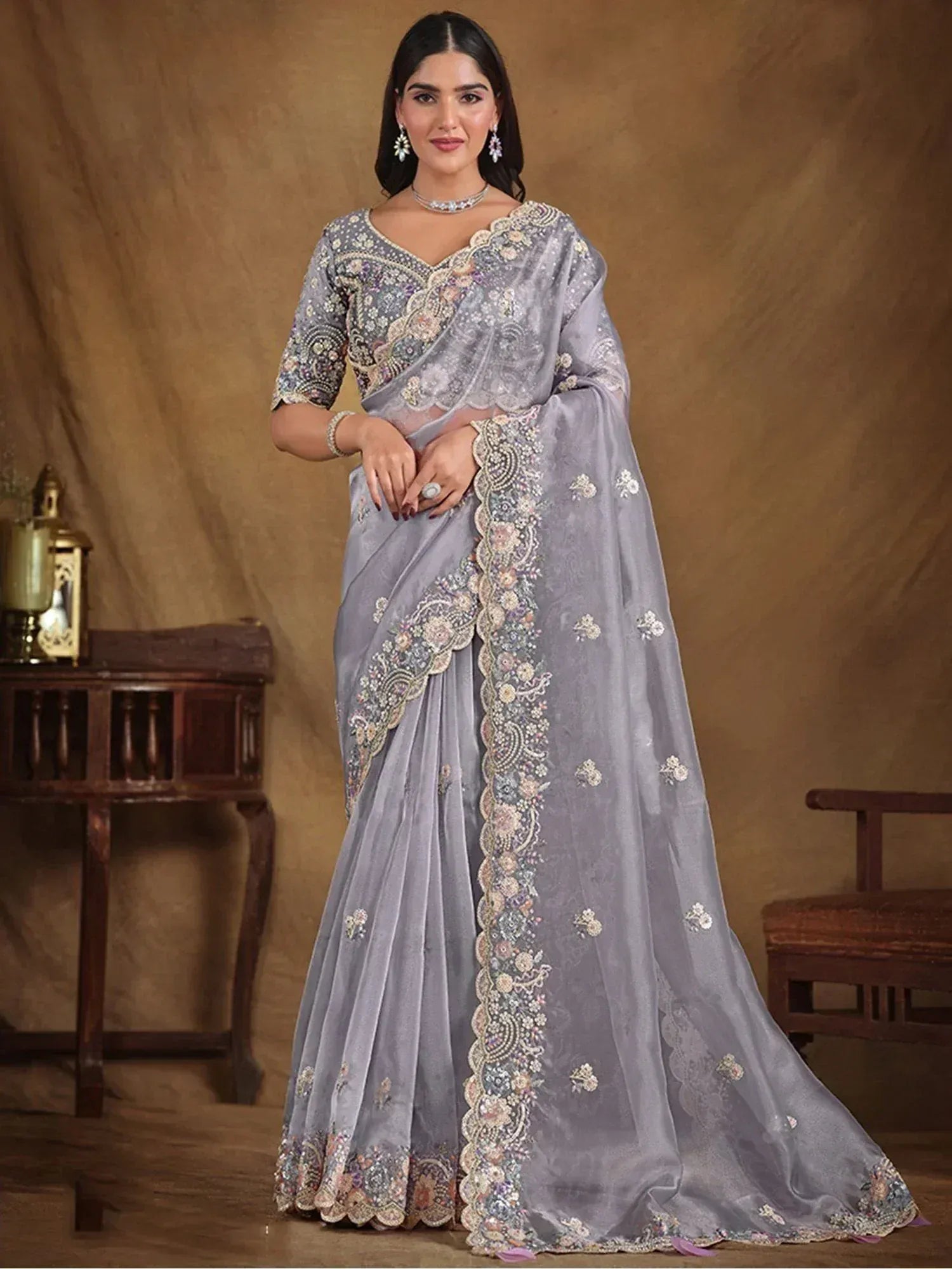 Elegant grey embroidered saree with floral motifs and scalloped border, perfect for Indian ethnic occasions.