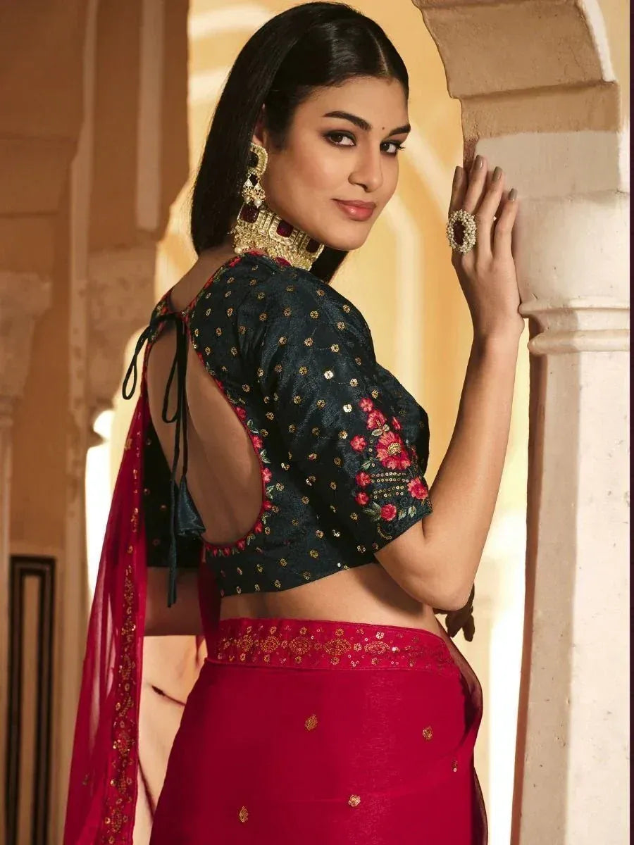 Elegant Indian ethnic wear with floral embroidered blouse and red skirt, perfect for festive occasions.