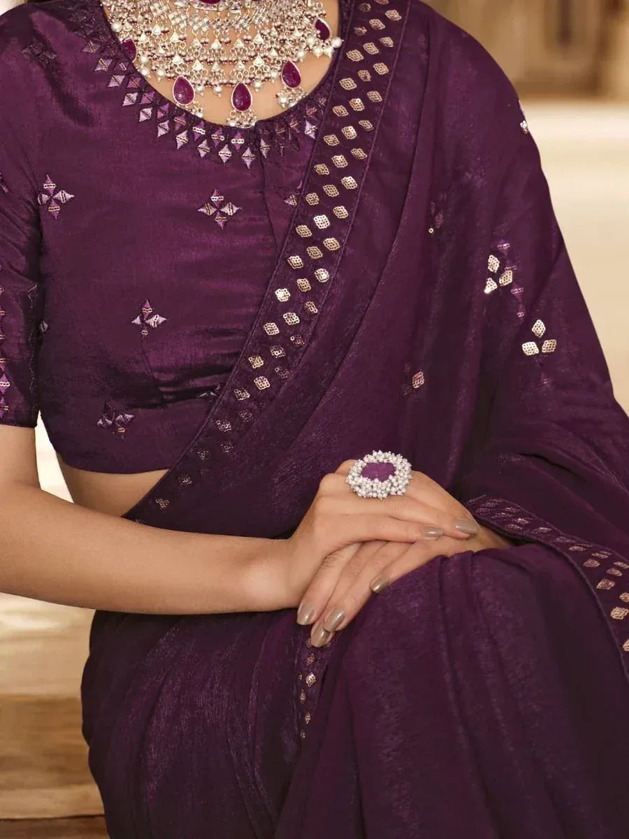 Purple designer saree with gold embroidery and matching jewelry for ethnic occasions