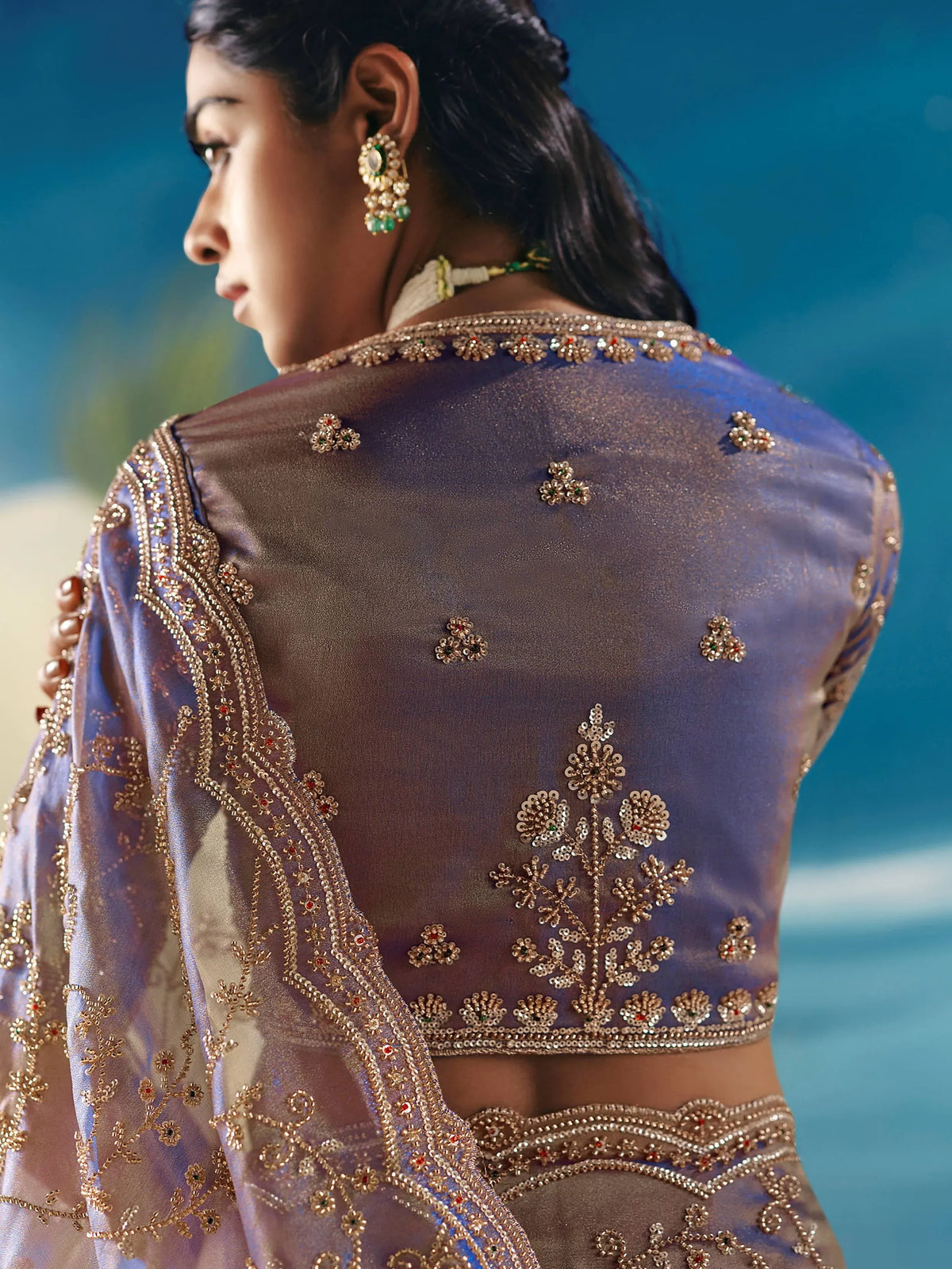 Purple designer lehenga choli with gold embroidery and floral beadwork, perfect for Indian ethnic wear.