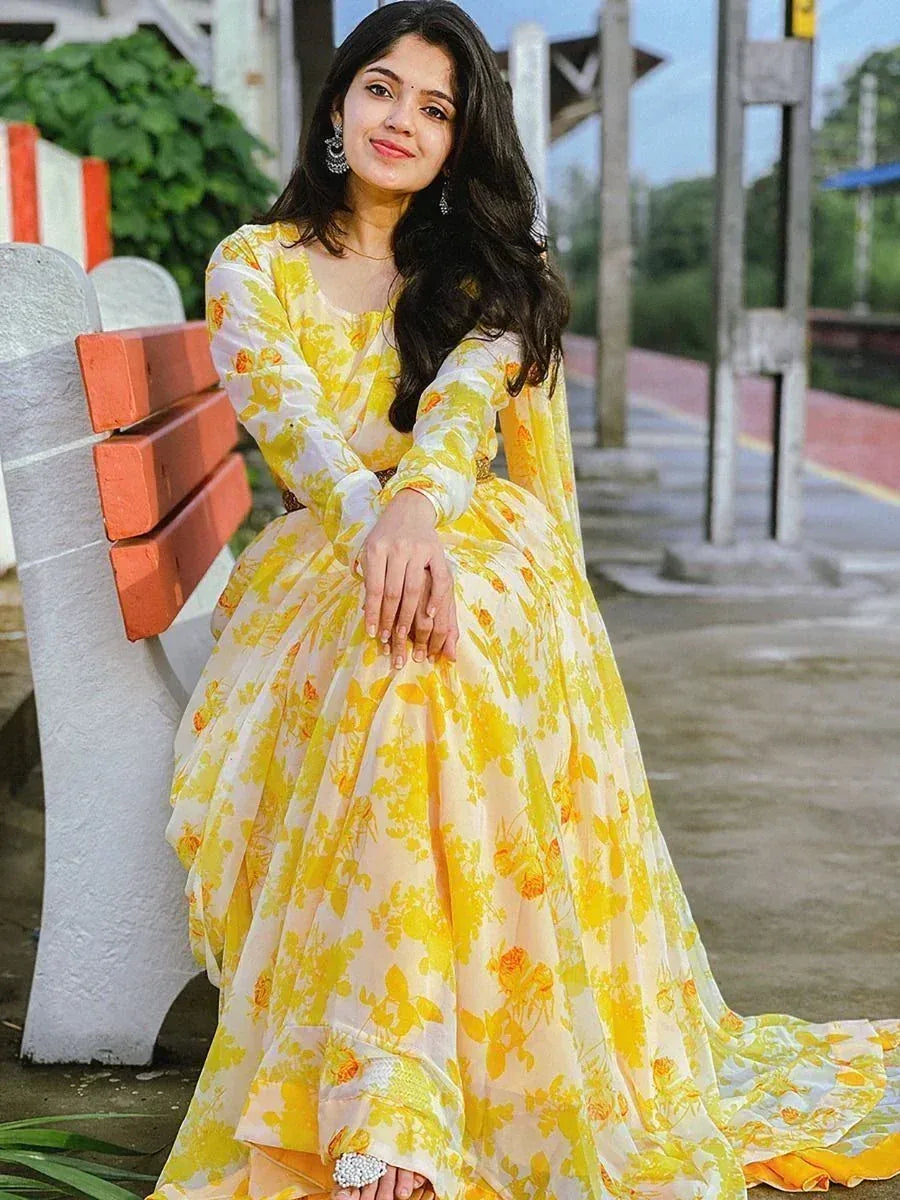 Yellow floral ethnic gown with long sleeves, perfect for Indian occasions and festive wear.