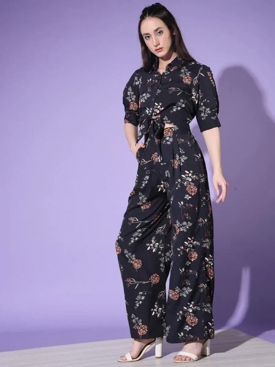 Black floral print ethnic jumpsuit with tie waist, wide legs, and short sleeves for women