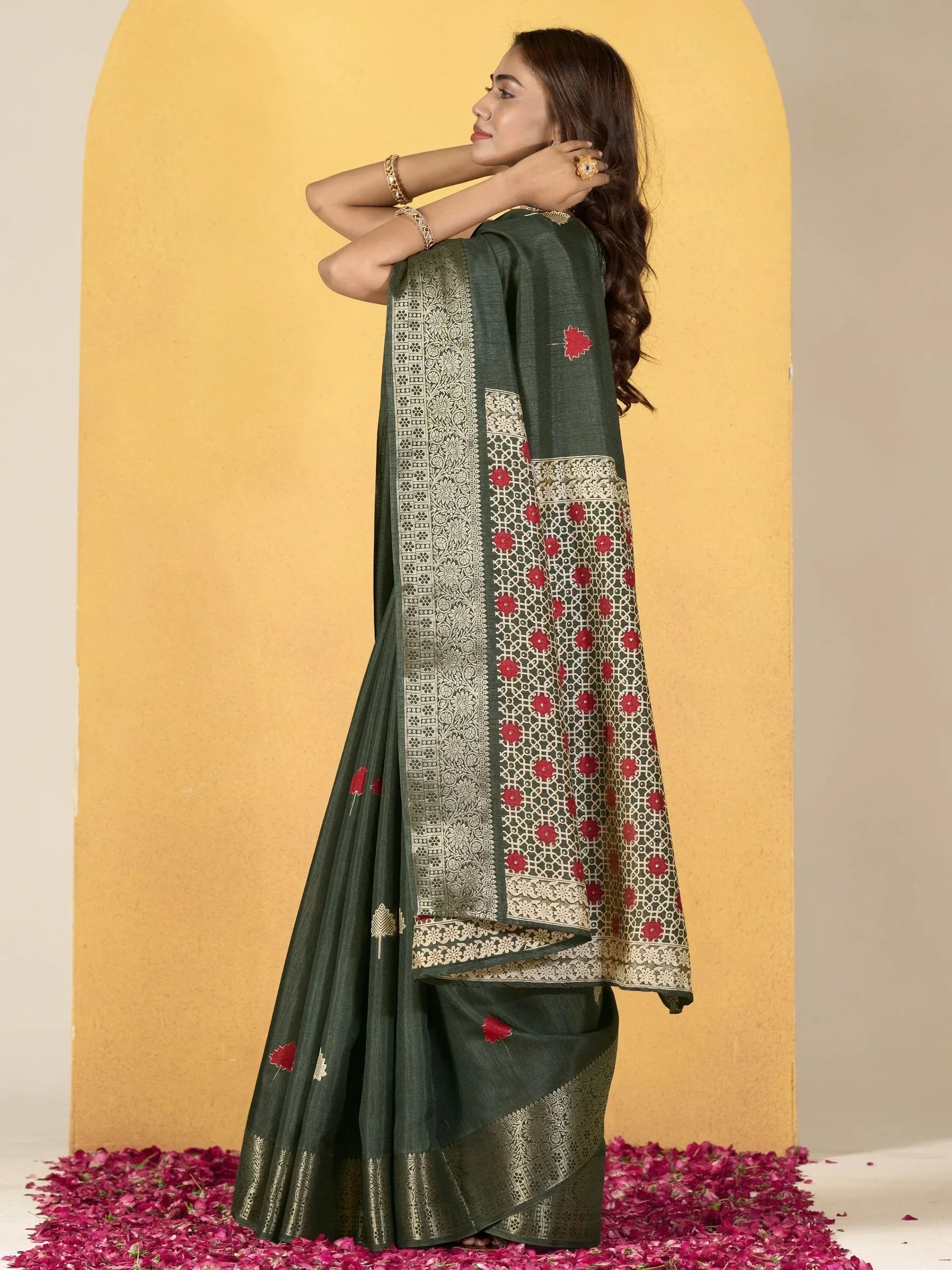 Green designer saree with red floral embroidery and gold border, perfect for Indian ethnic wear occasions.