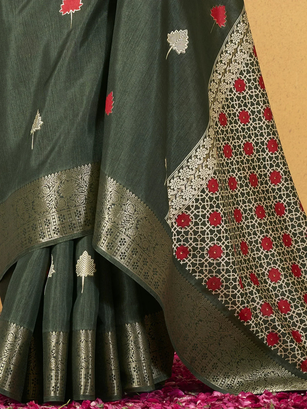 Dark green ethnic saree with red floral embroidery and gold zari border, perfect for Indian occasions.