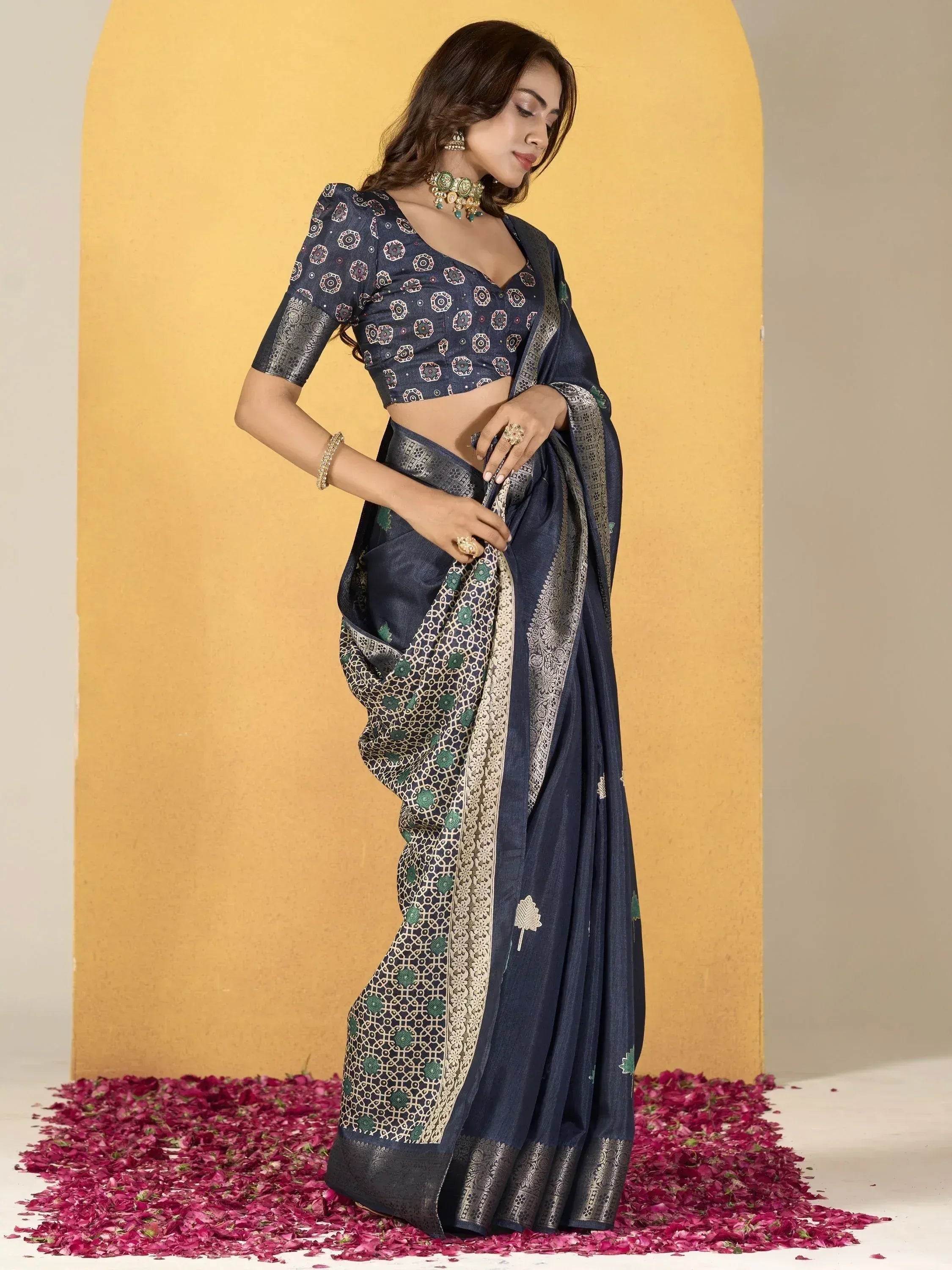 Navy blue designer saree with gold and green embroidery, paired with matching blouse, ideal for ethnic occasions