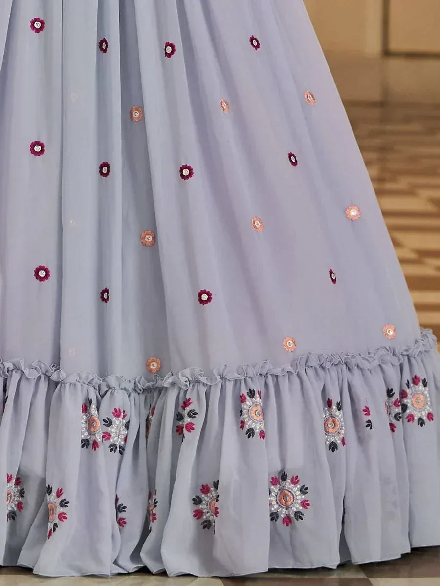 Light grey ethnic gown with floral embroidery and ruffled hem, perfect for Indian occasions