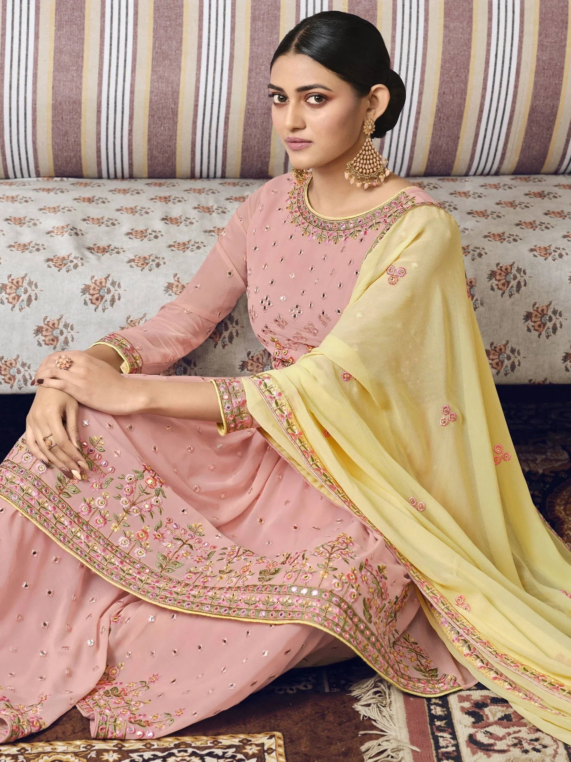 Woman in pink and yellow embroidered ethnic anarkali suit with statement earrings
