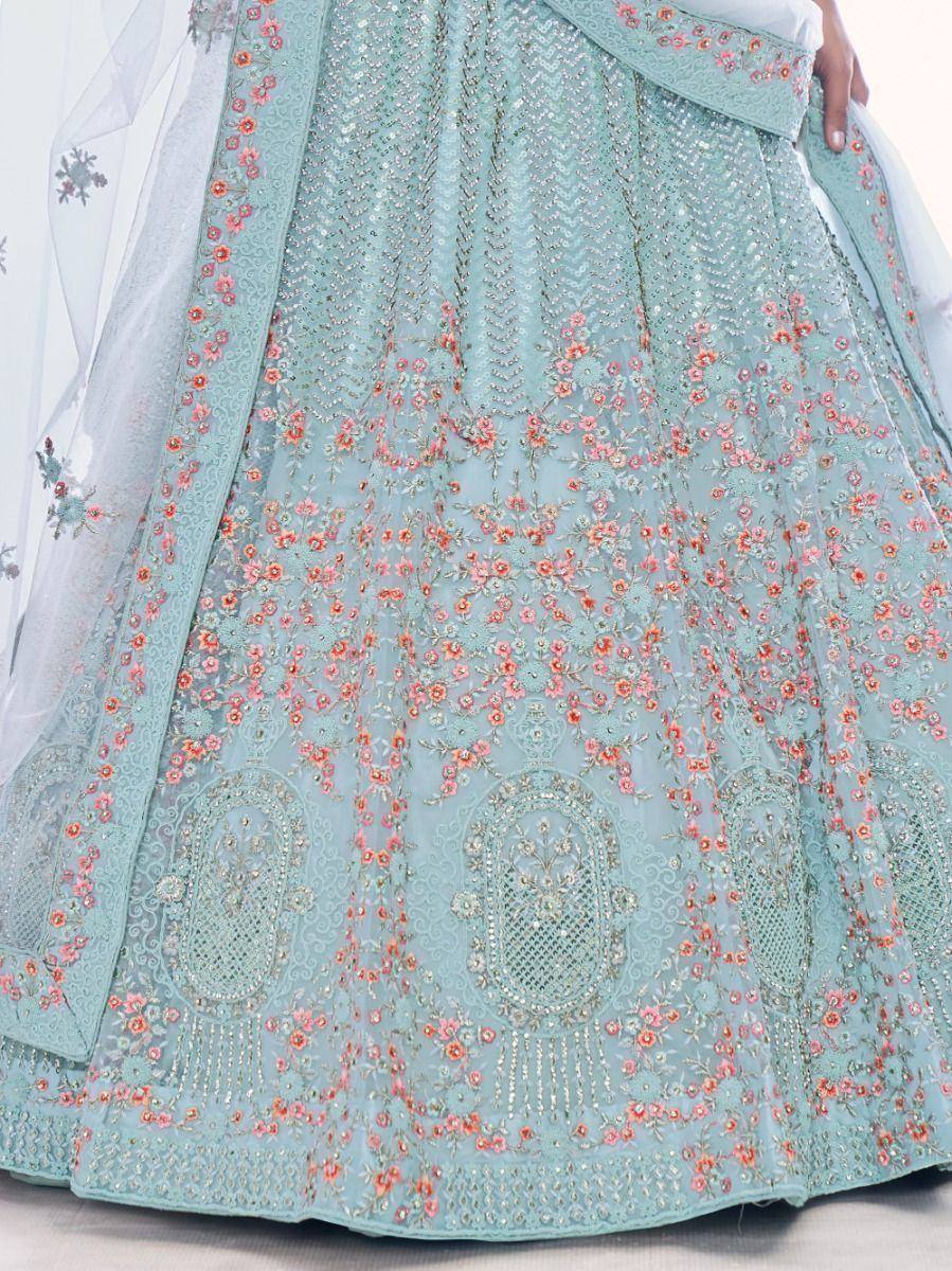 Mint green designer lehenga with pink floral embroidery and sequin work, perfect for Indian weddings.