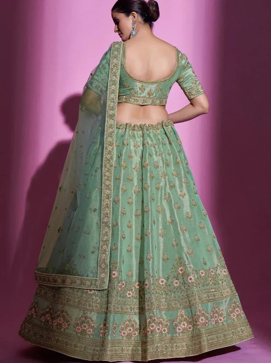 Mint green designer lehenga choli with gold floral embroidery and sheer dupatta, perfect for Indian weddings