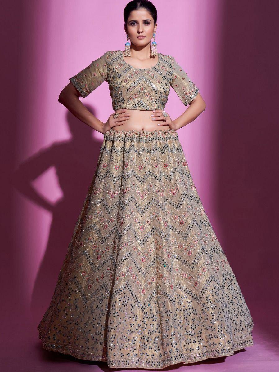 Beige embroidered lehenga choli with mirror work, perfect for Indian weddings and festive occasions