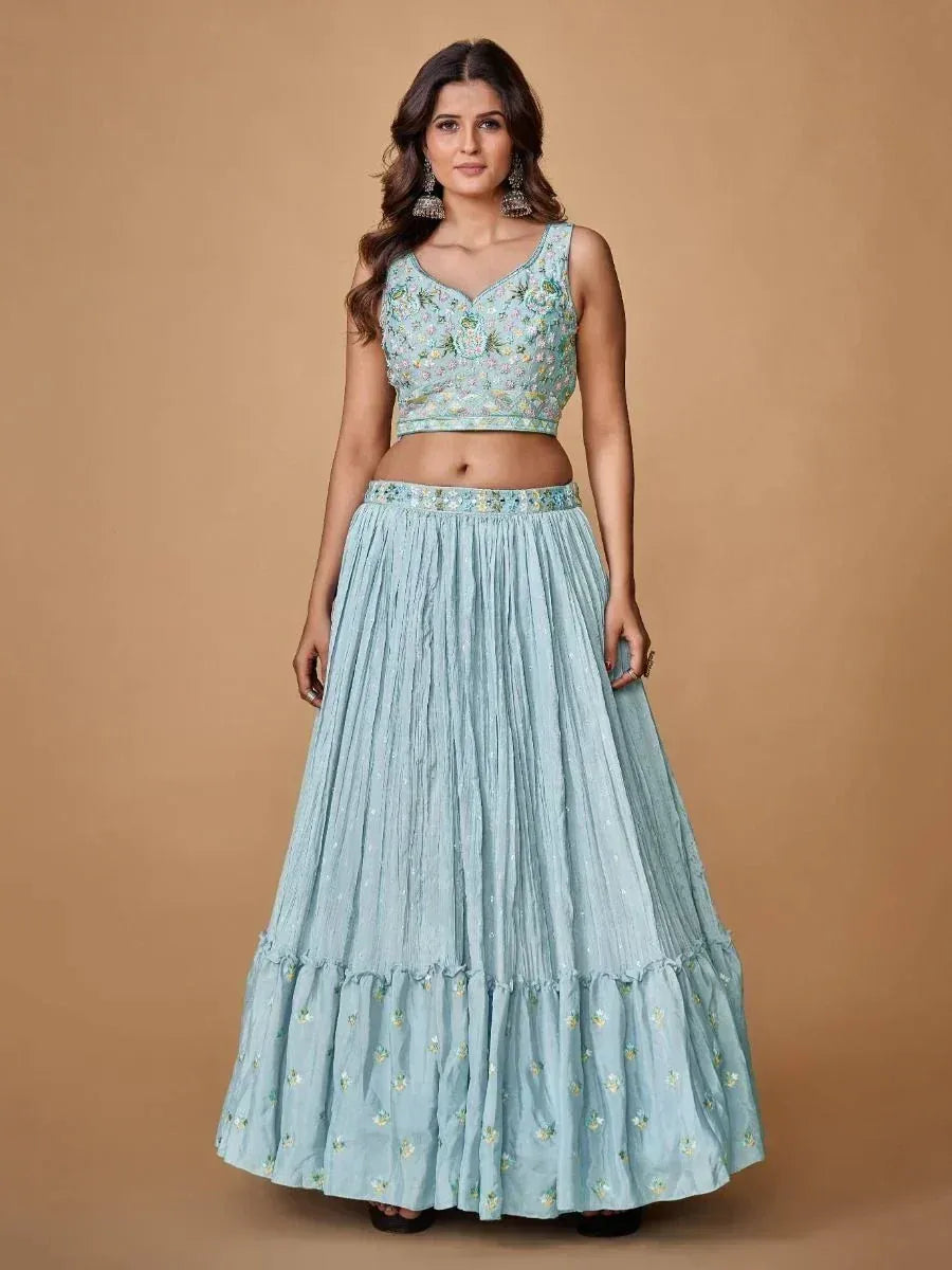 Light blue embroidered lehenga choli with floral motifs and pleated skirt, perfect for Indian ethnic occasions.