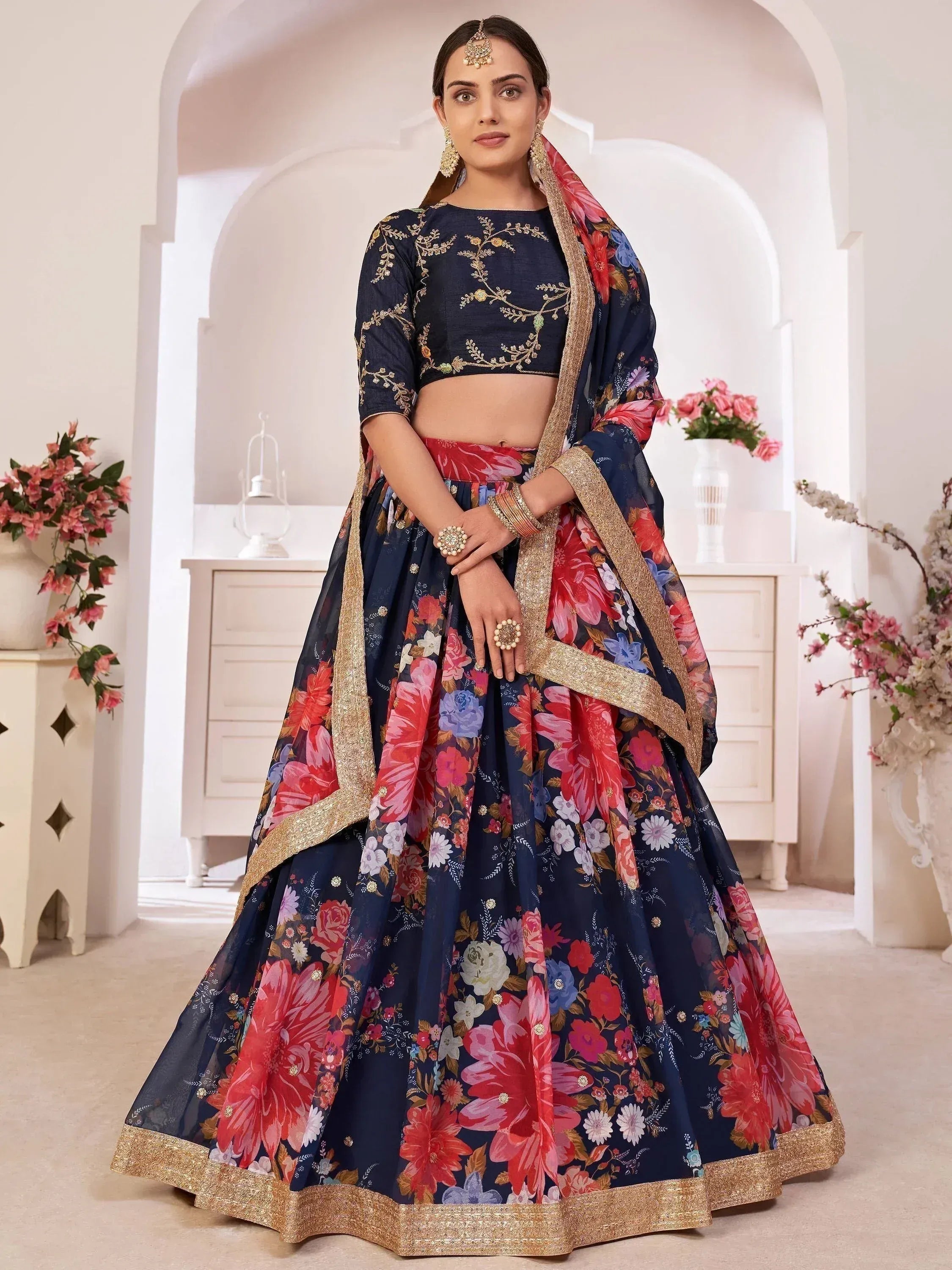 Navy blue floral lehenga choli with gold embroidery, perfect for Indian weddings and festive occasions.