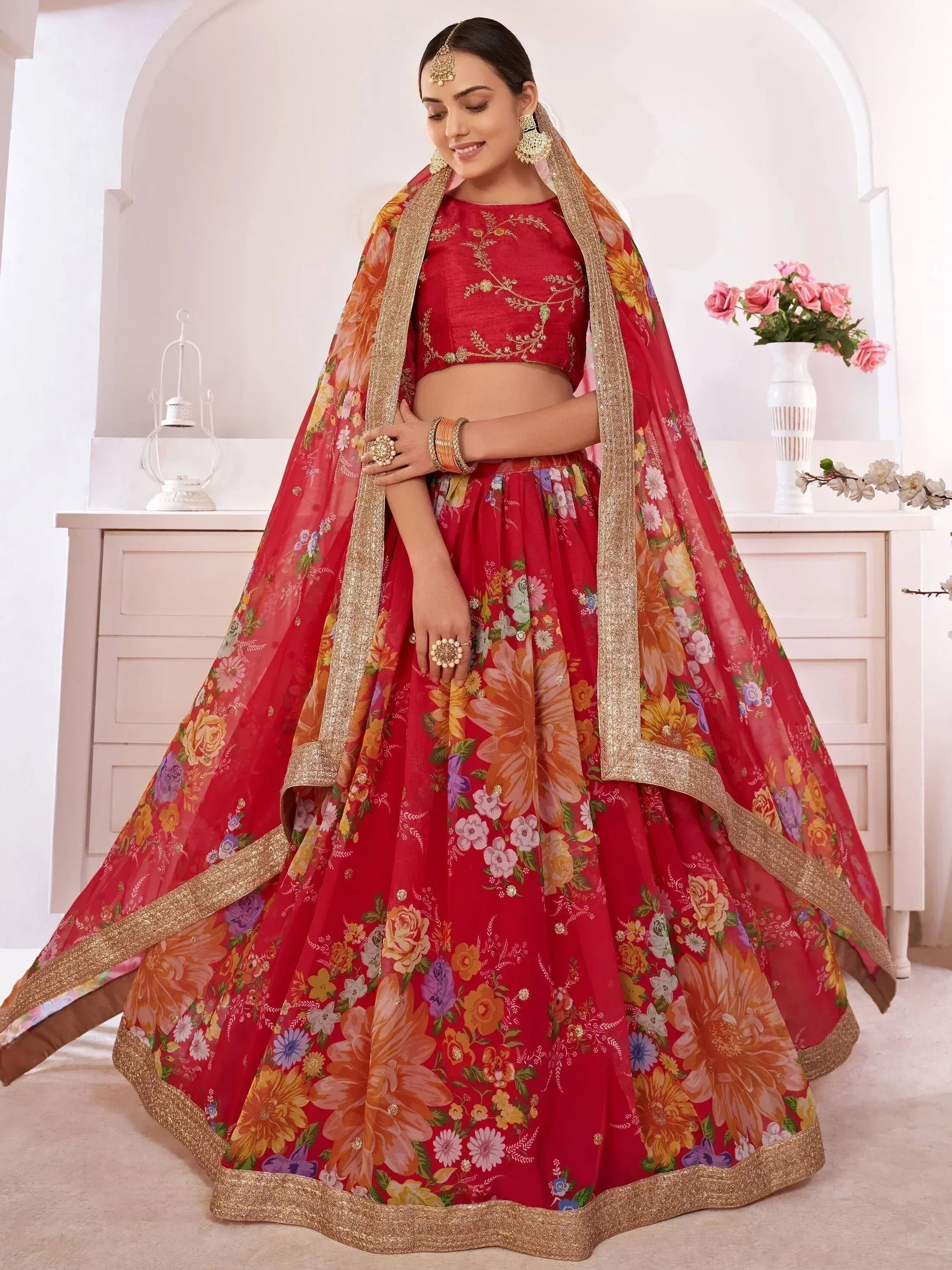 Red floral lehenga choli with gold trim, perfect for Indian weddings and festive occasions