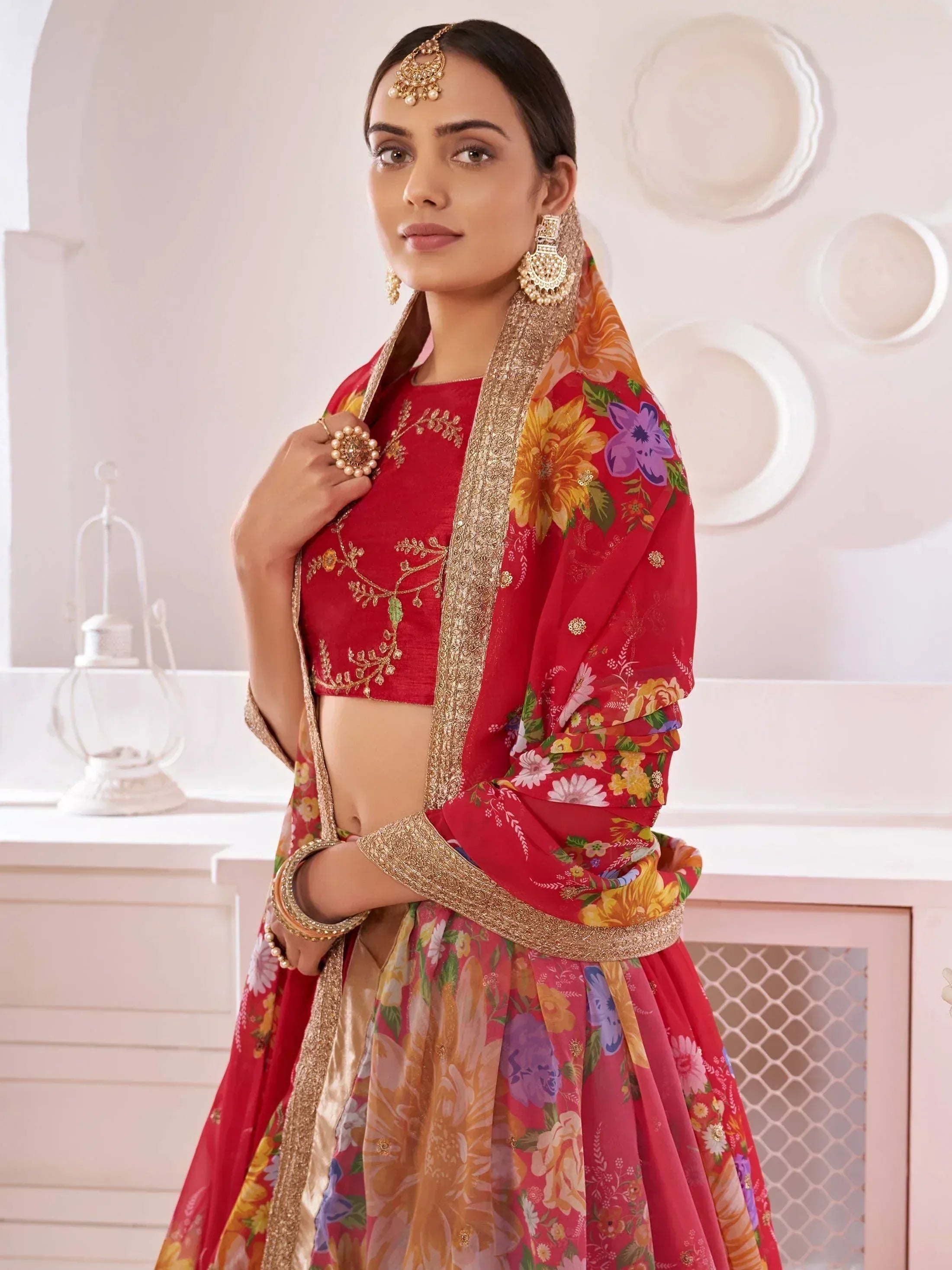 Red floral lehenga choli with gold embroidery, perfect for Indian ethnic wear and festive occasions.