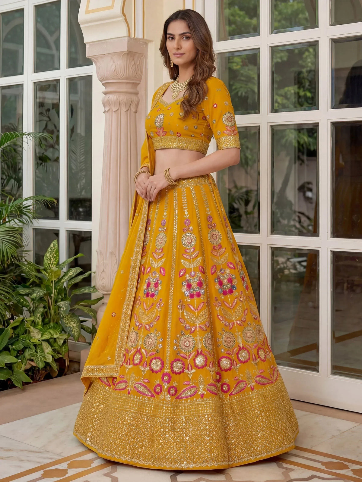 Yellow embroidered lehenga choli with floral motifs, perfect for Indian ethnic wear and festive occasions.