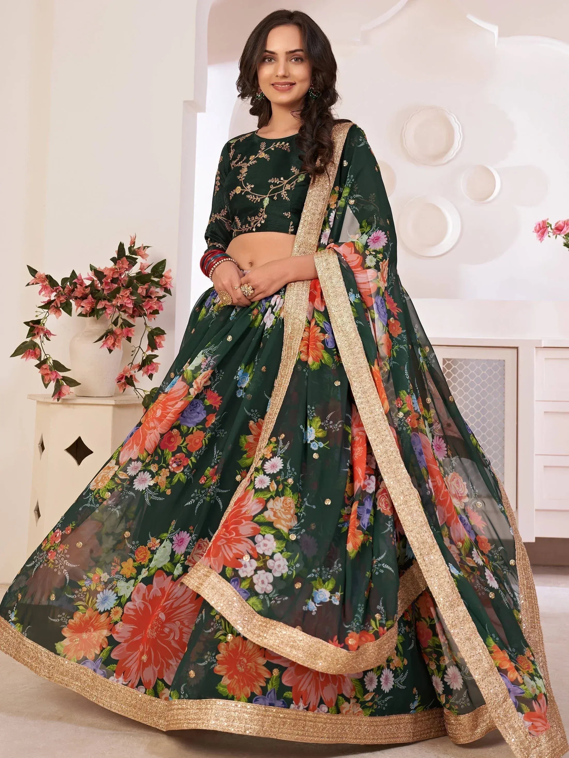 Green floral lehenga choli with gold embroidery and sequin border, perfect for Indian ethnic occasions.