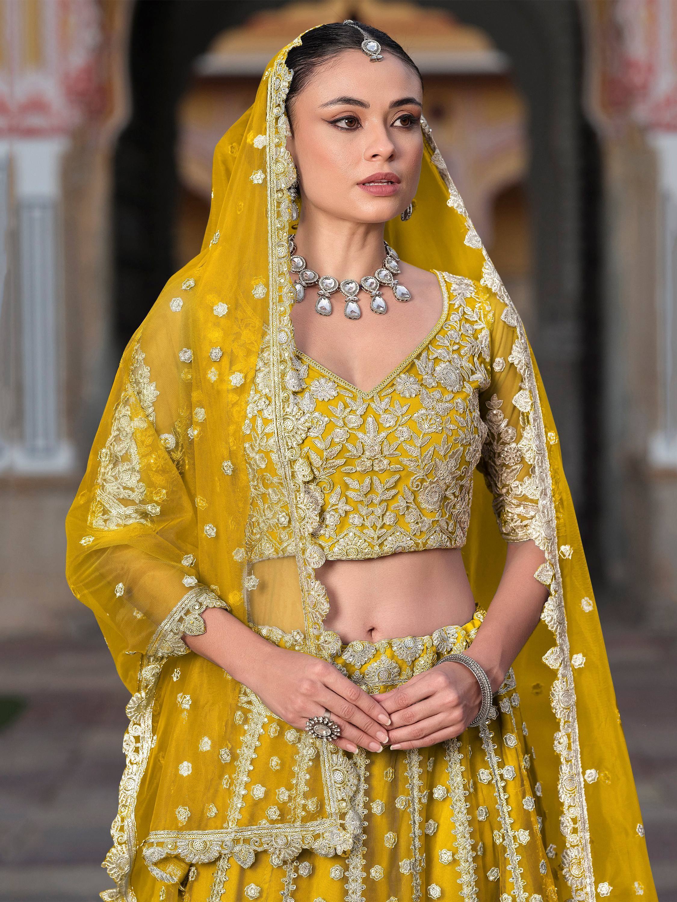 Yellow embroidered lehenga choli with floral detailing and matching dupatta for Indian ethnic wear