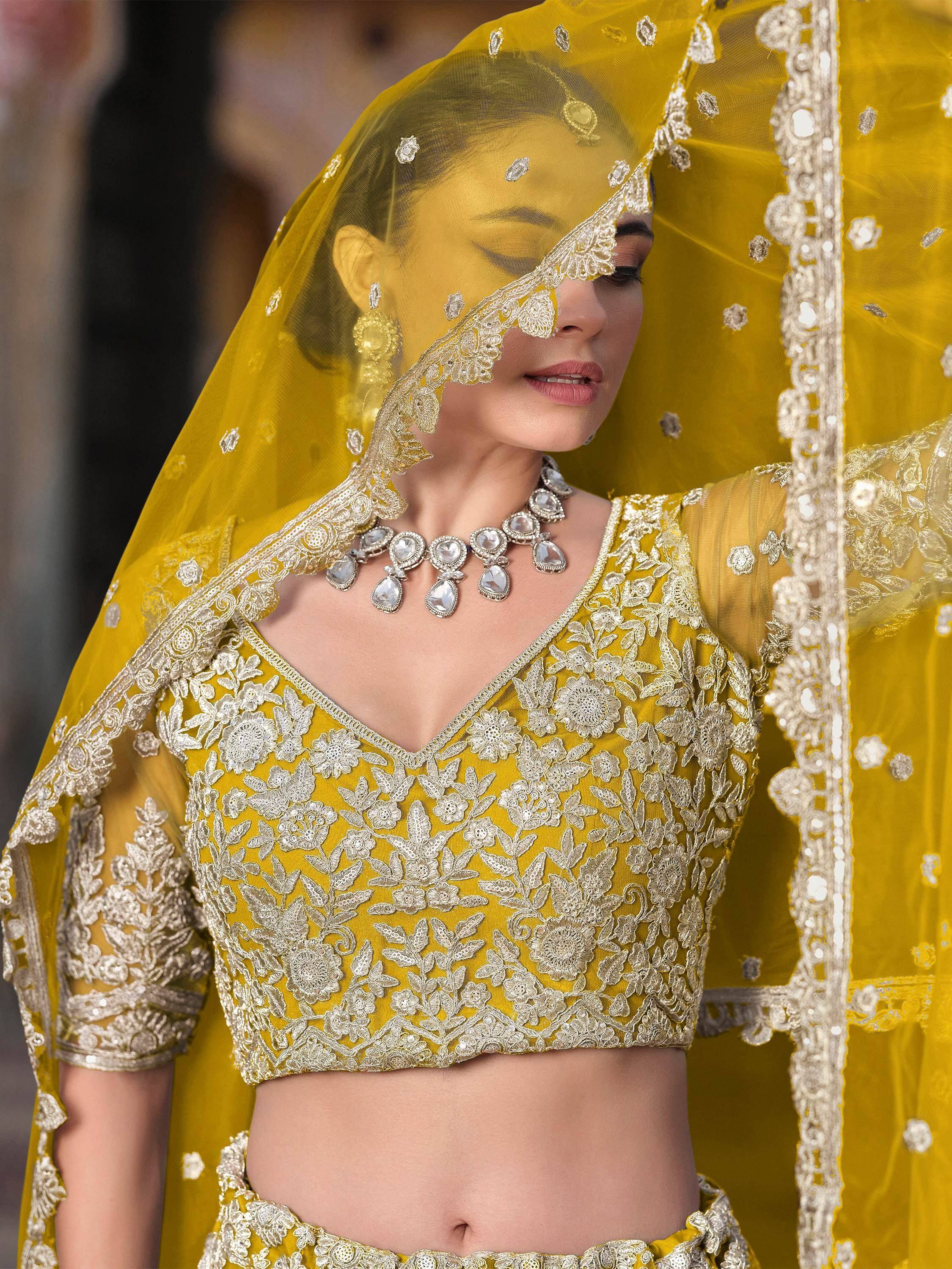 Yellow embroidered lehenga choli with floral lace and matching dupatta for Indian ethnic wear