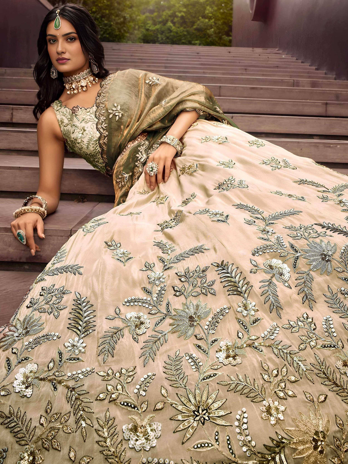 Elegant beige lehenga choli with intricate floral embroidery and gold detailing, perfect for Indian weddings and festive occasions.