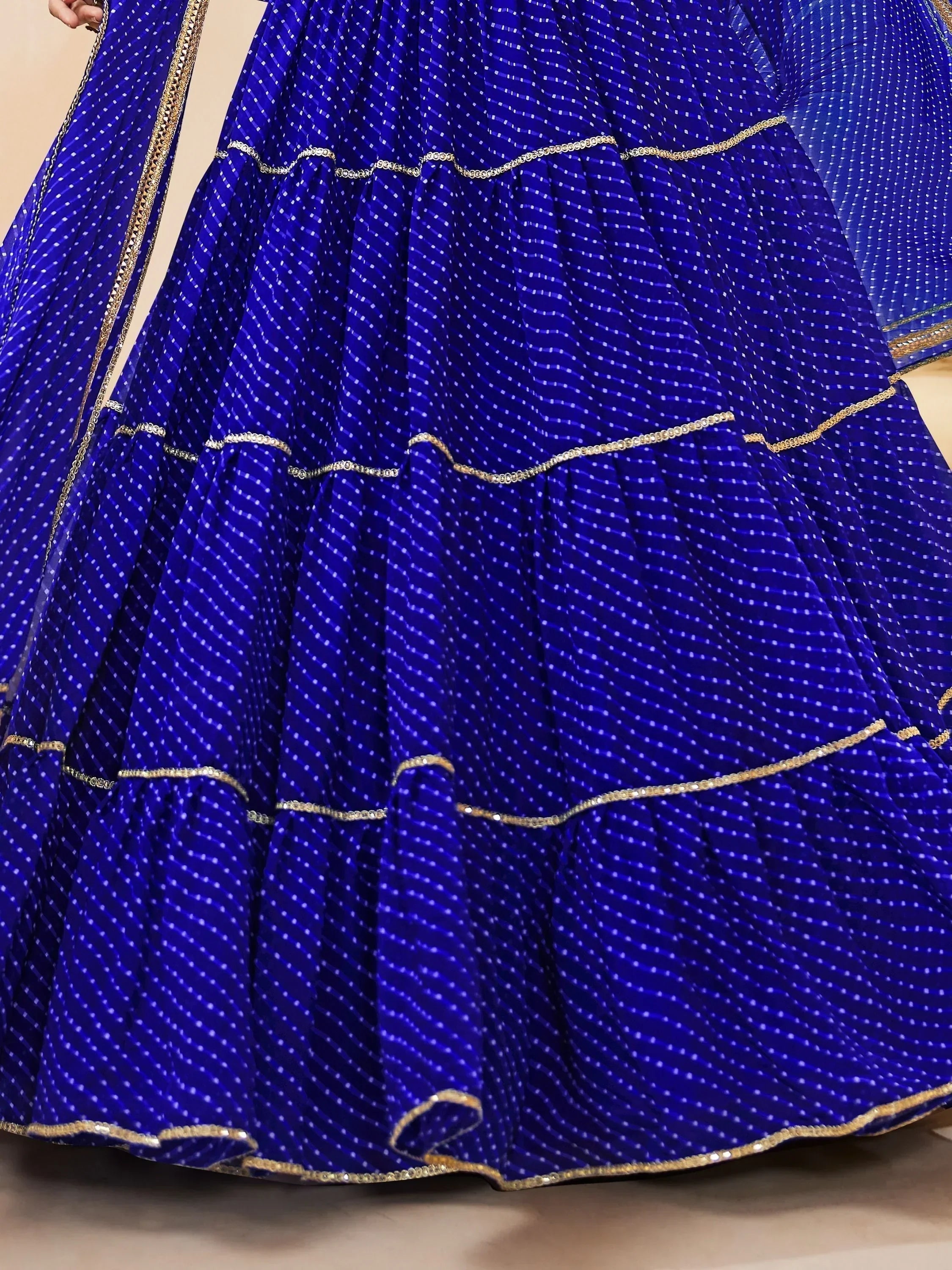 Royal blue lehenga with gold embroidery and pleated skirt, perfect for Indian ethnic wear occasions