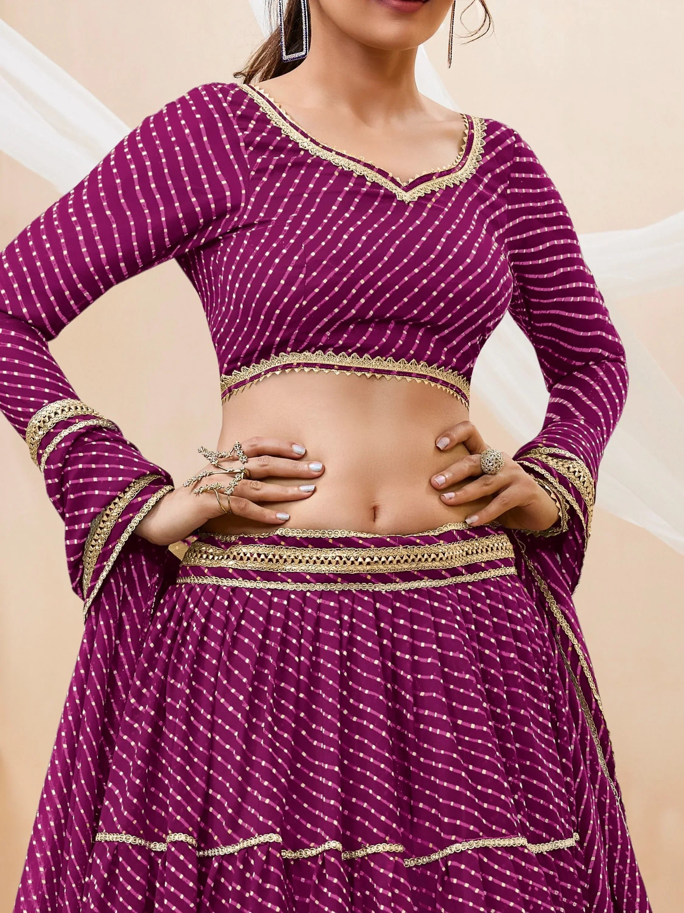 Purple ethnic lehenga choli with gold trim and striped pattern, perfect for Indian weddings and festivals