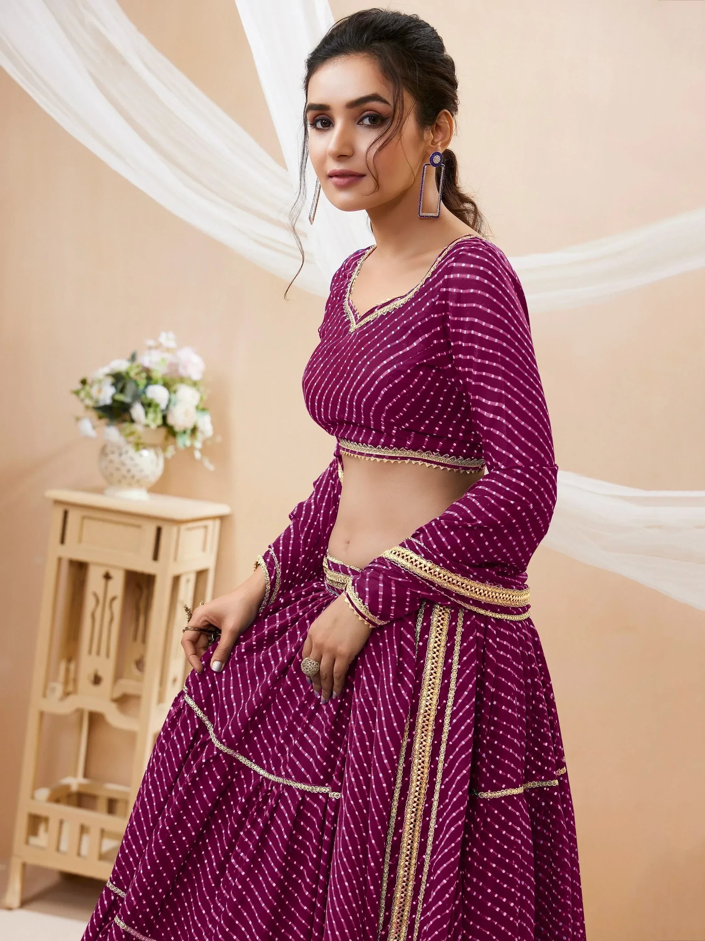 Purple ethnic lehenga choli with gold trim, perfect for Indian weddings and festive occasions
