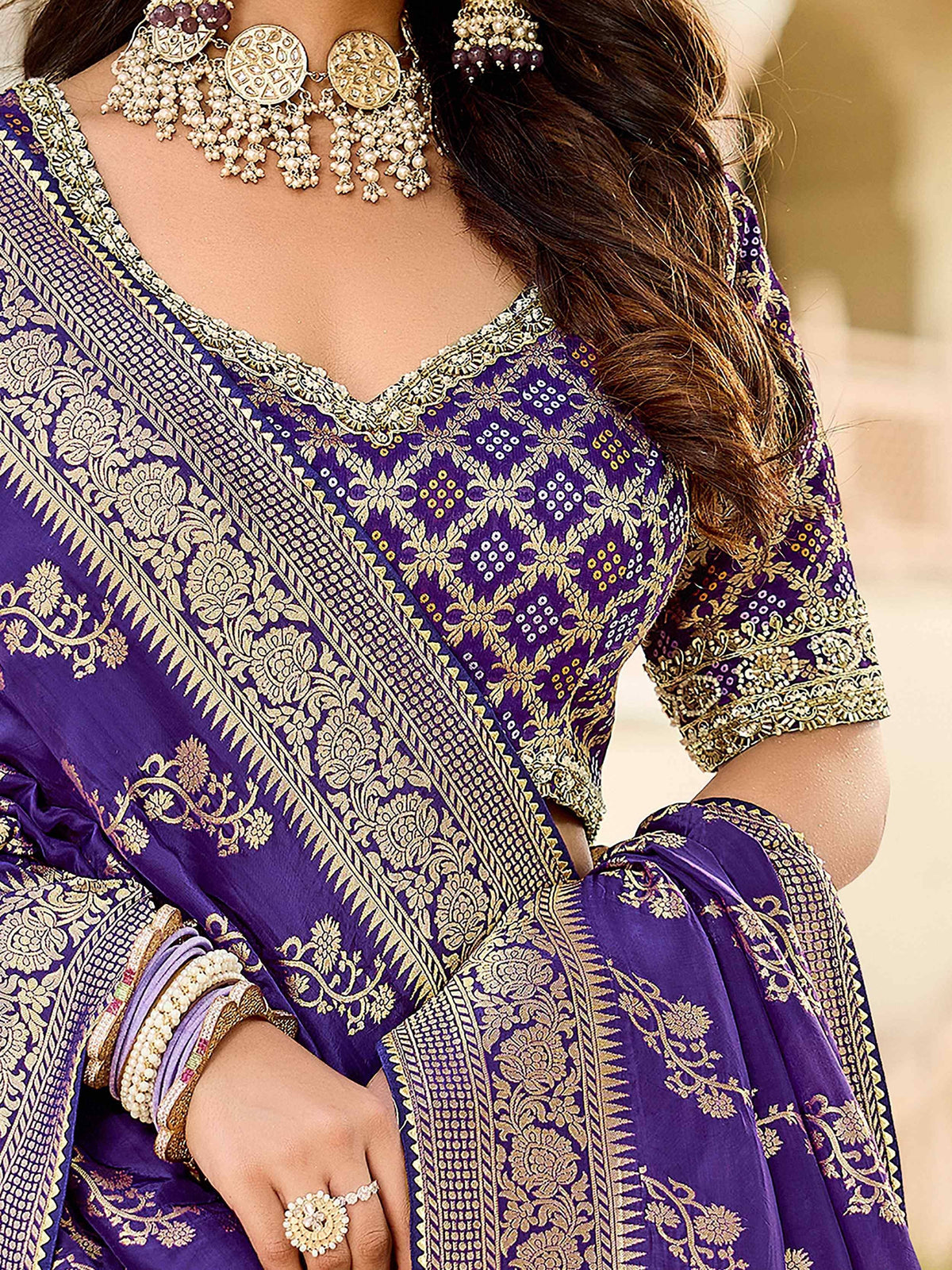 Purple ethnic saree with gold floral embroidery and matching jewelry for Indian occasions