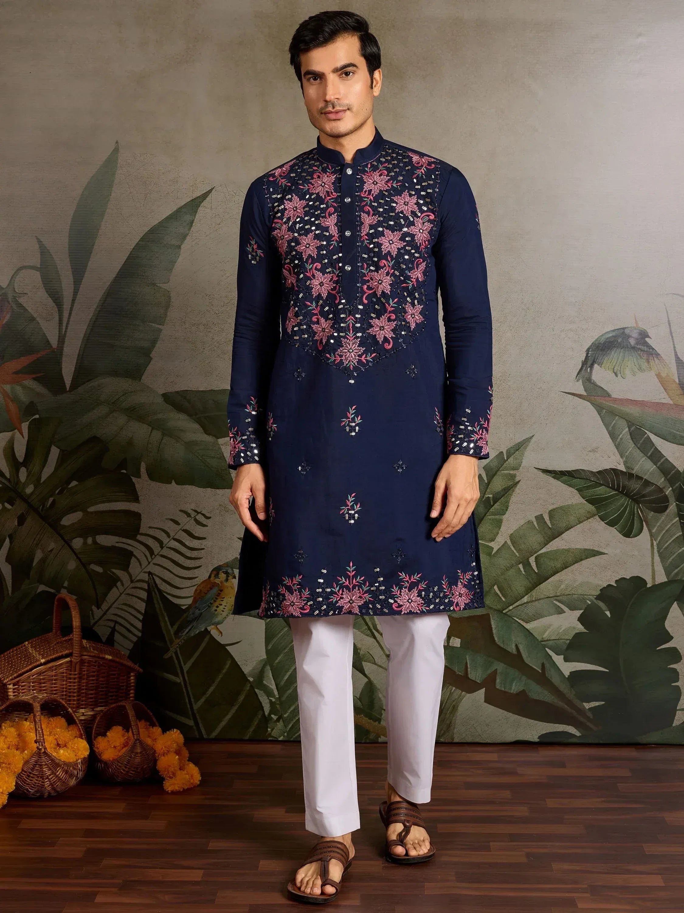 Navy blue embroidered kurta with pink floral motifs, paired with white pants for men's ethnic wear