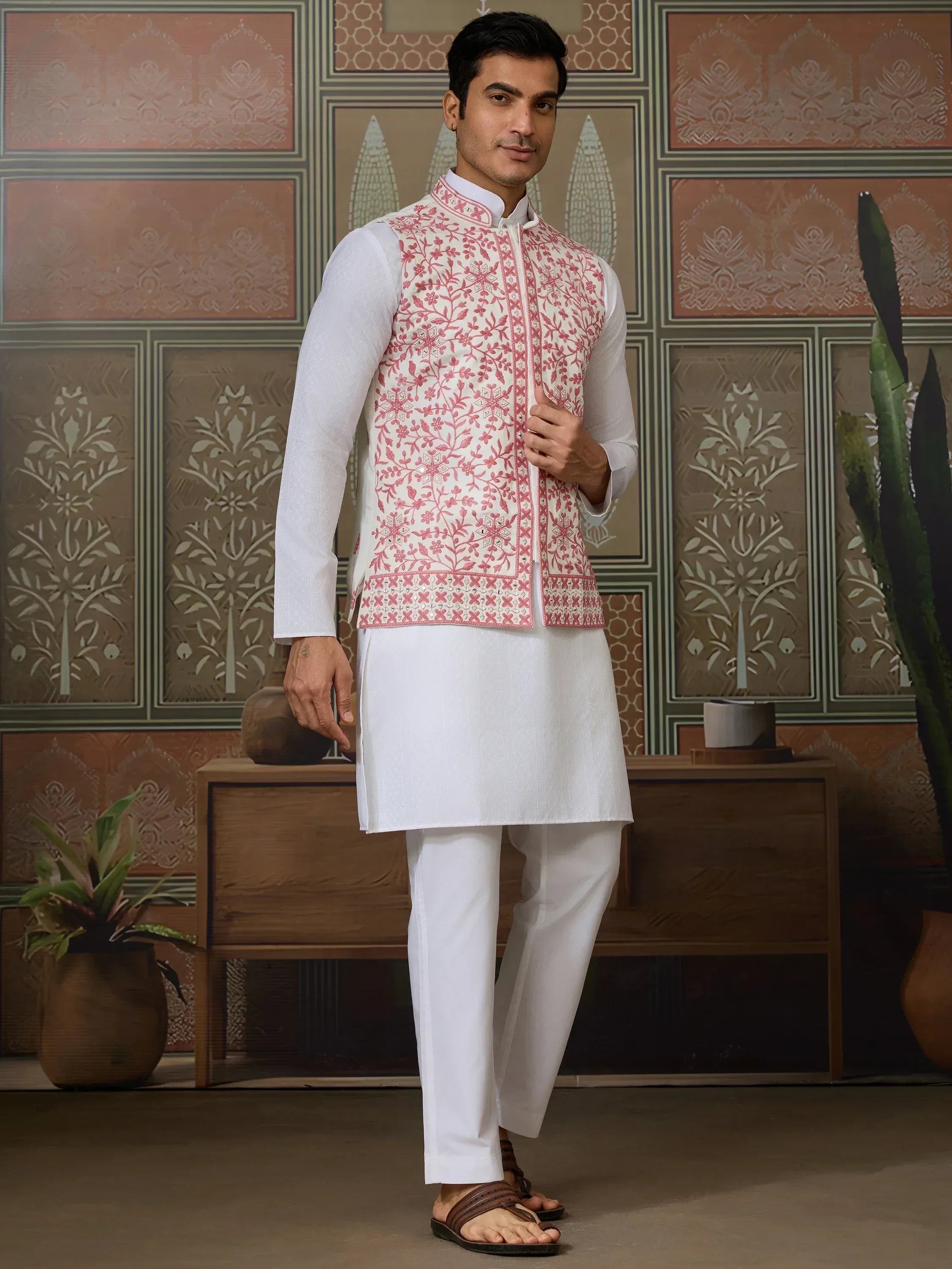 Man in white kurta pajama with pink floral embroidered Nehru jacket, Indian ethnic wear