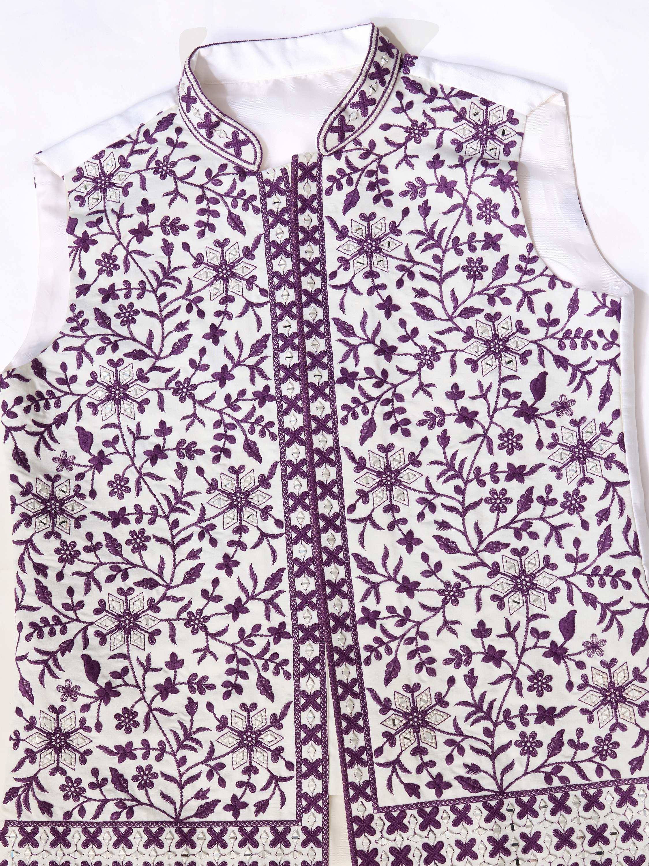 White sleeveless ethnic jacket with purple floral embroidery and mirror work, perfect for Indian wear.