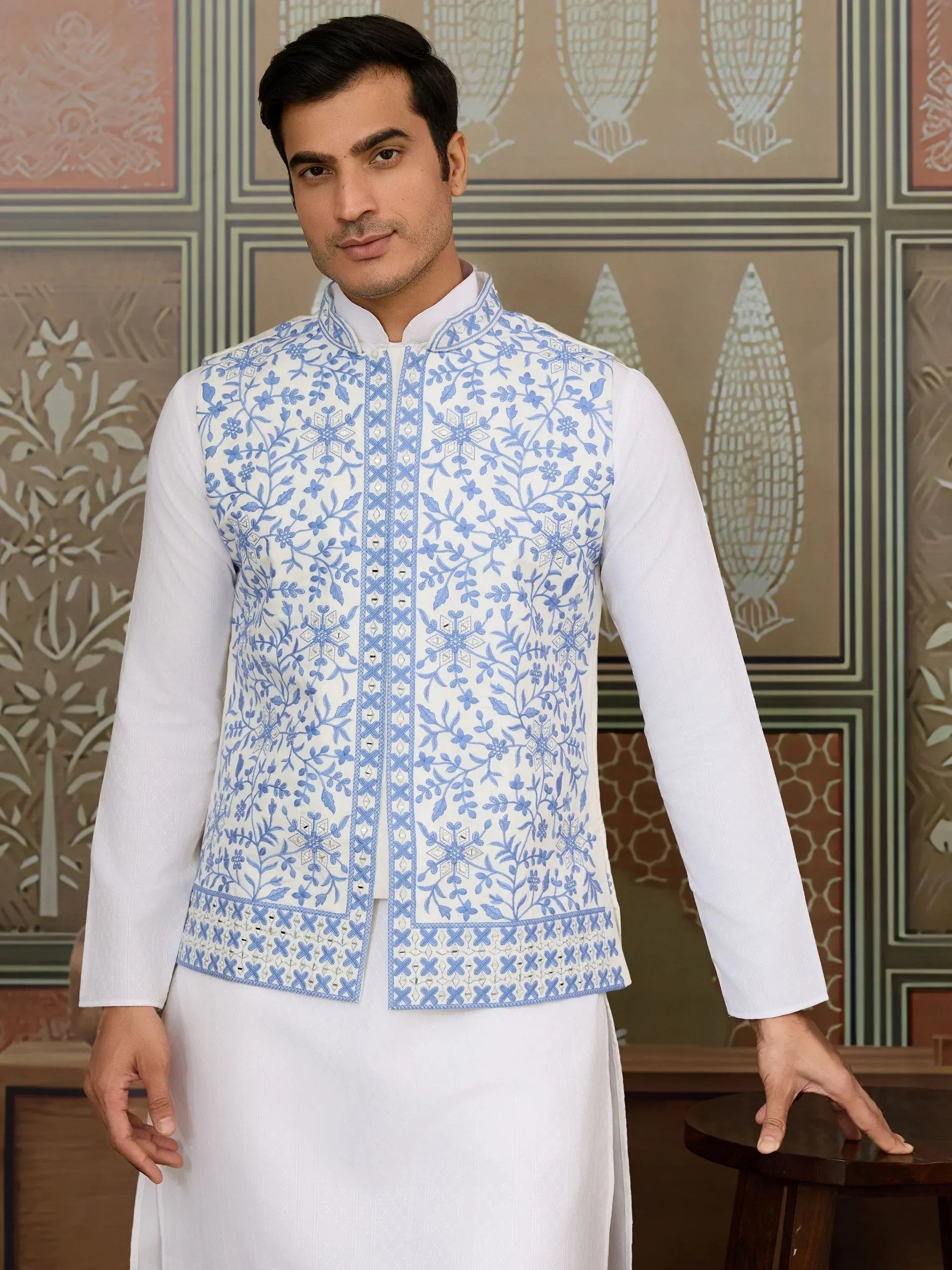 Man in white kurta with blue floral embroidered waistcoat, Indian ethnic wear