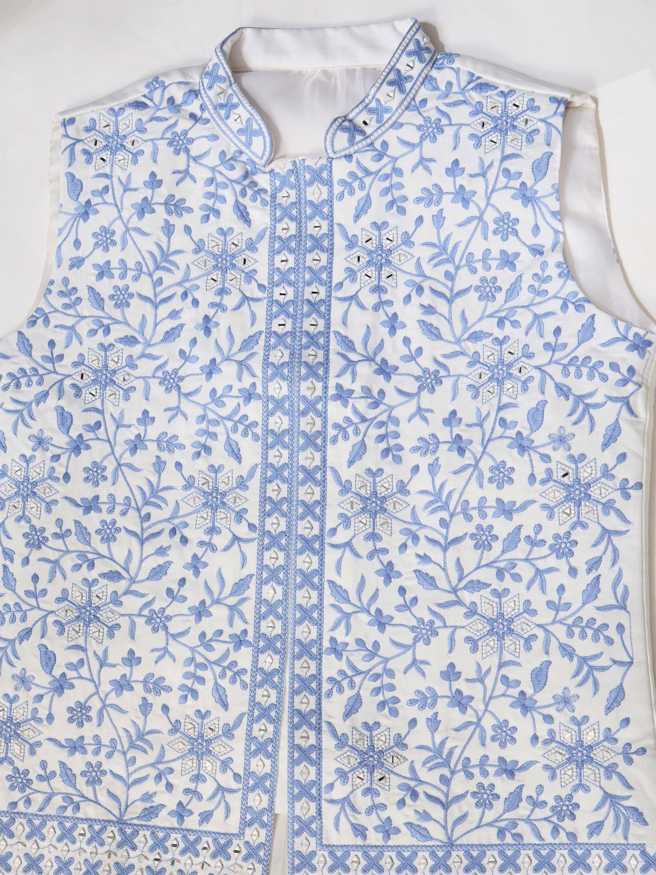 White sleeveless ethnic jacket with blue floral embroidery and mirror work, perfect for Indian wear.