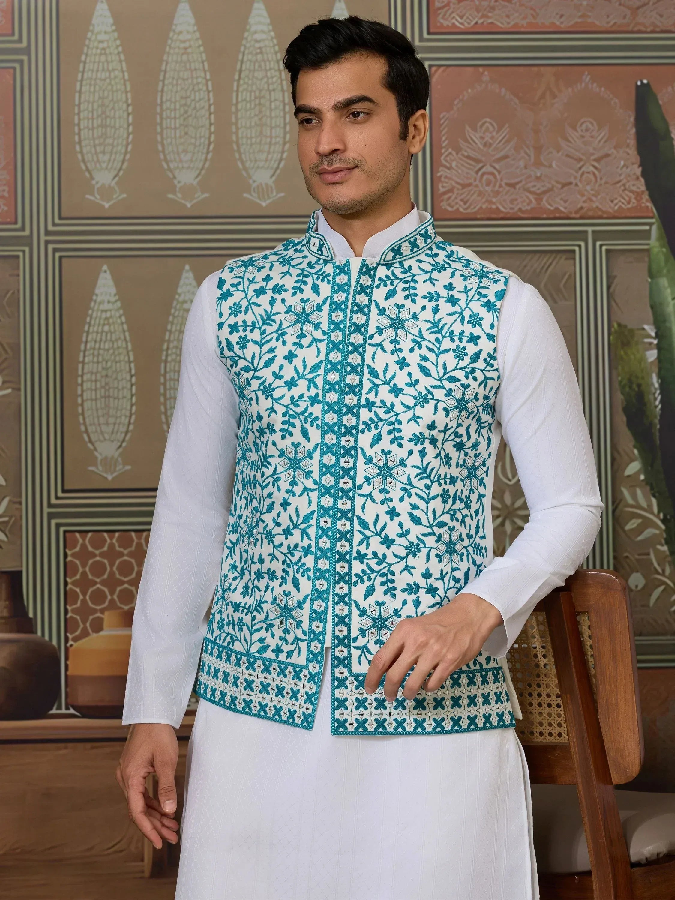 Man wearing white kurta with teal floral embroidered Nehru jacket, Indian ethnic wear