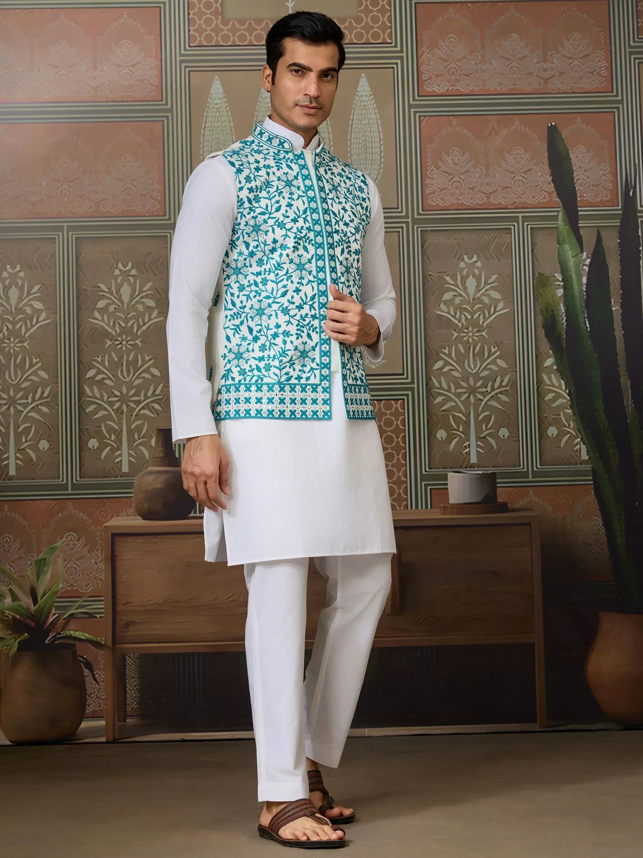Man in white kurta pajama with teal embroidered Nehru jacket, ethnic Indian wear