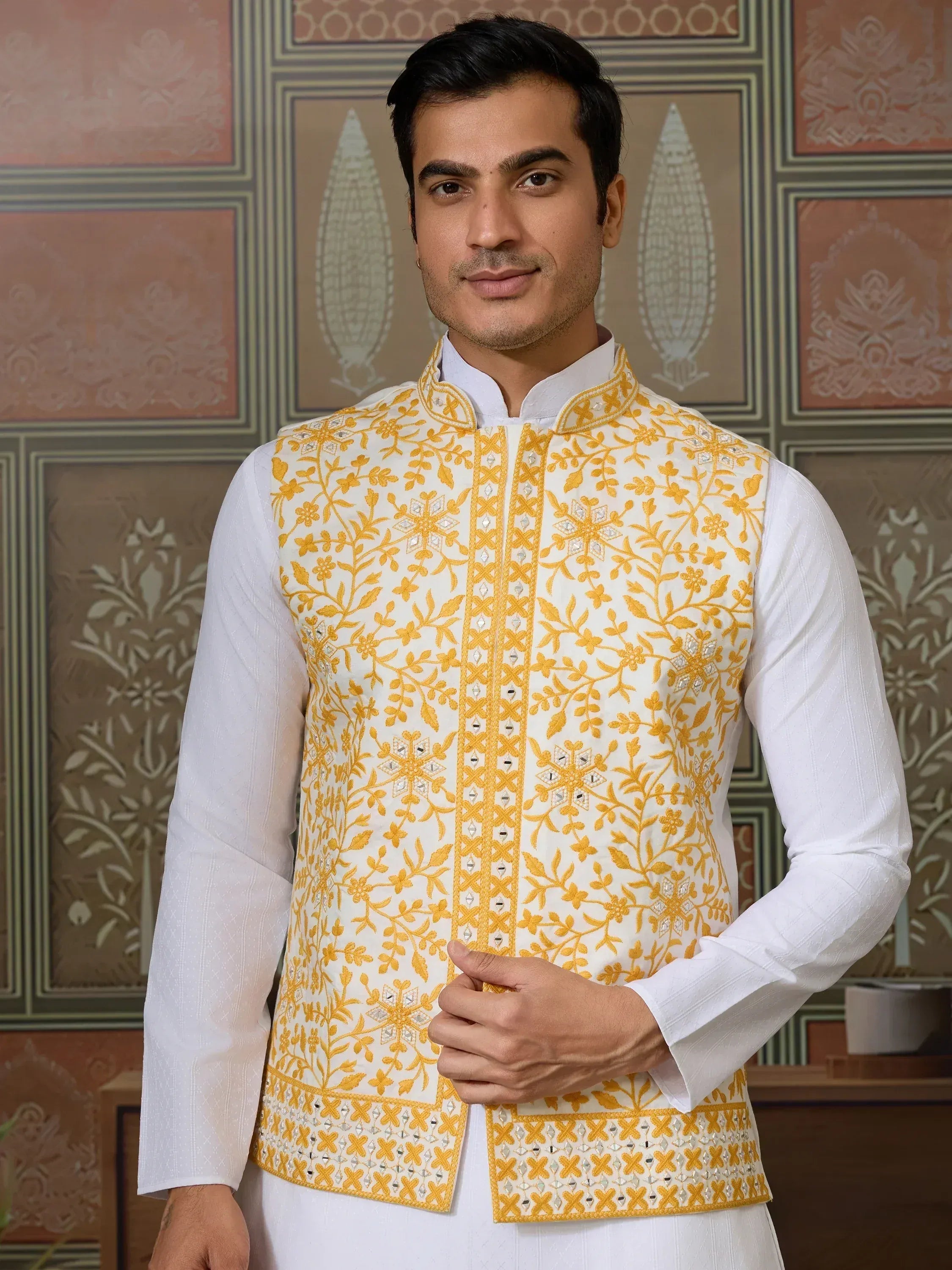 Men's white and yellow embroidered Nehru jacket with floral design, perfect for Indian ethnic wear occasions.