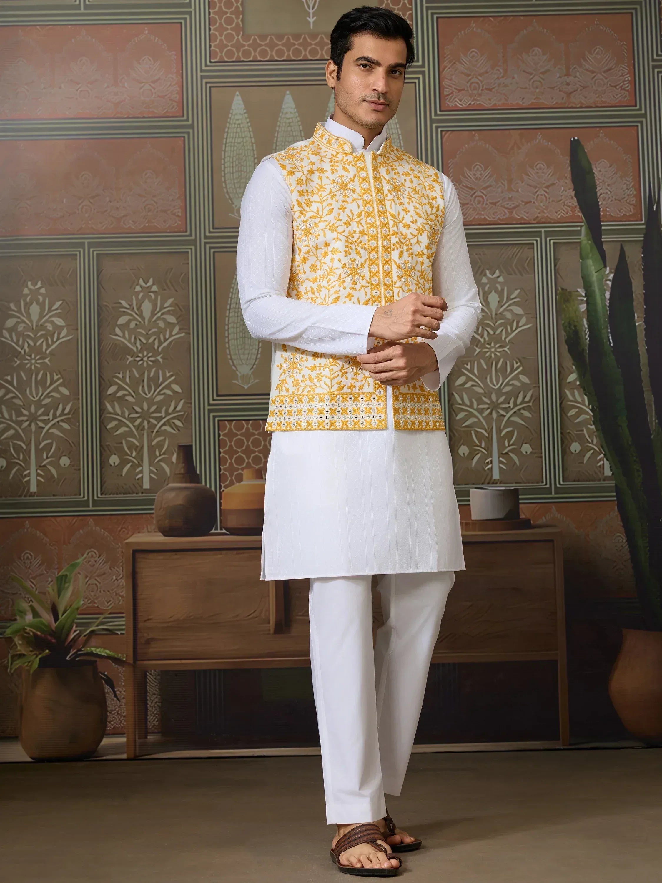Man in white kurta pajama with yellow embroidered waistcoat, Indian ethnic wear
