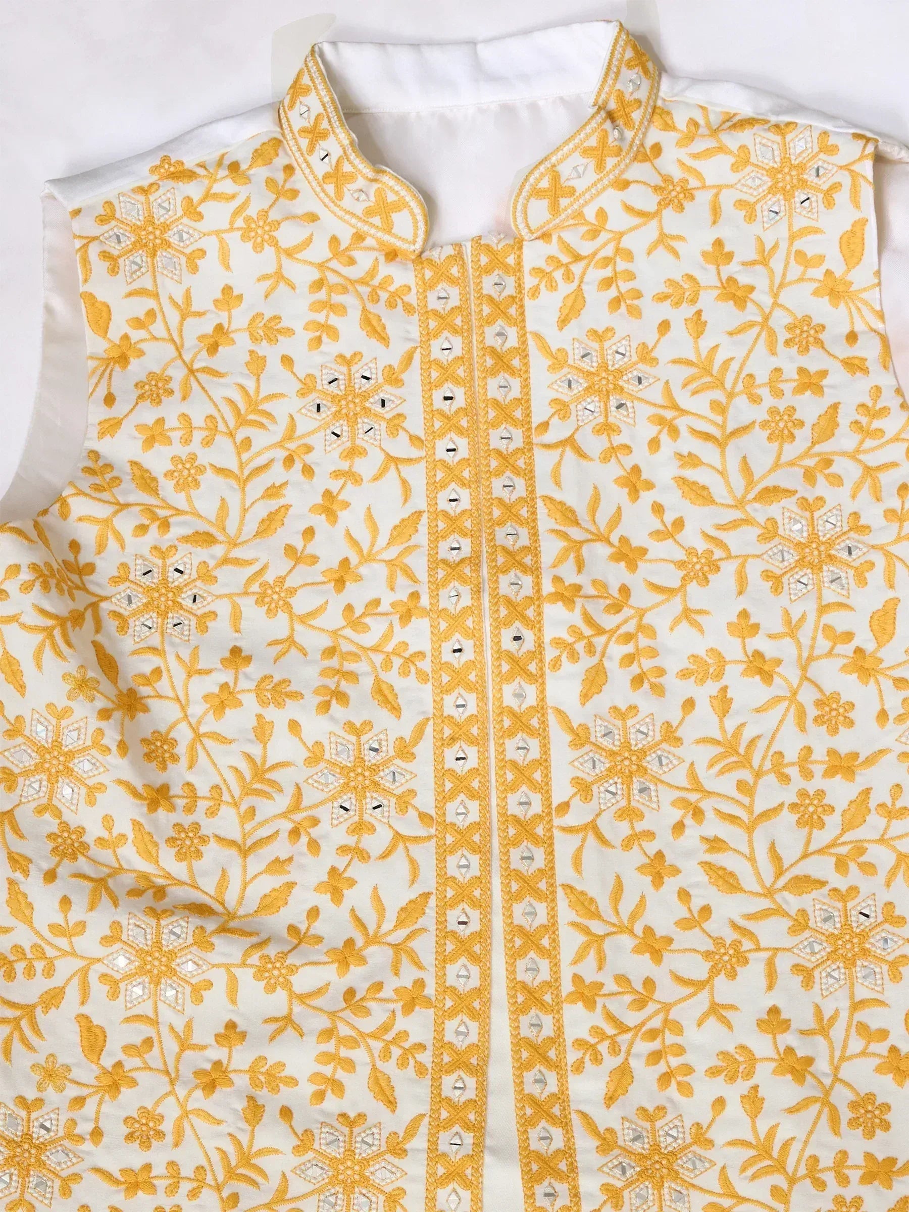 White ethnic vest with yellow floral embroidery and mirror work, perfect for Indian wear