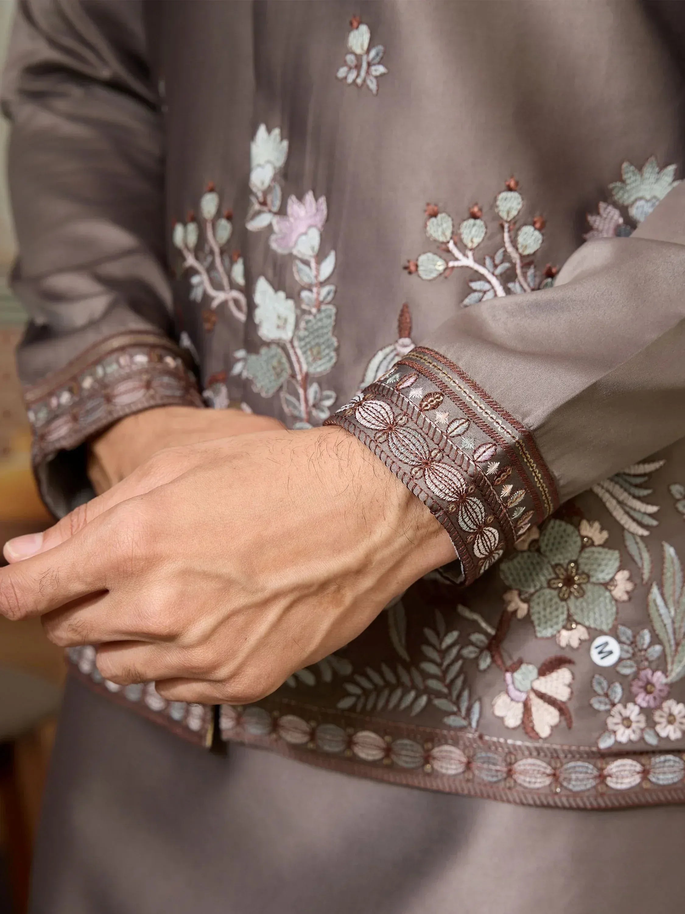 Men's ethnic kurta with floral embroidery and detailed cuffs, perfect for Indian festive wear