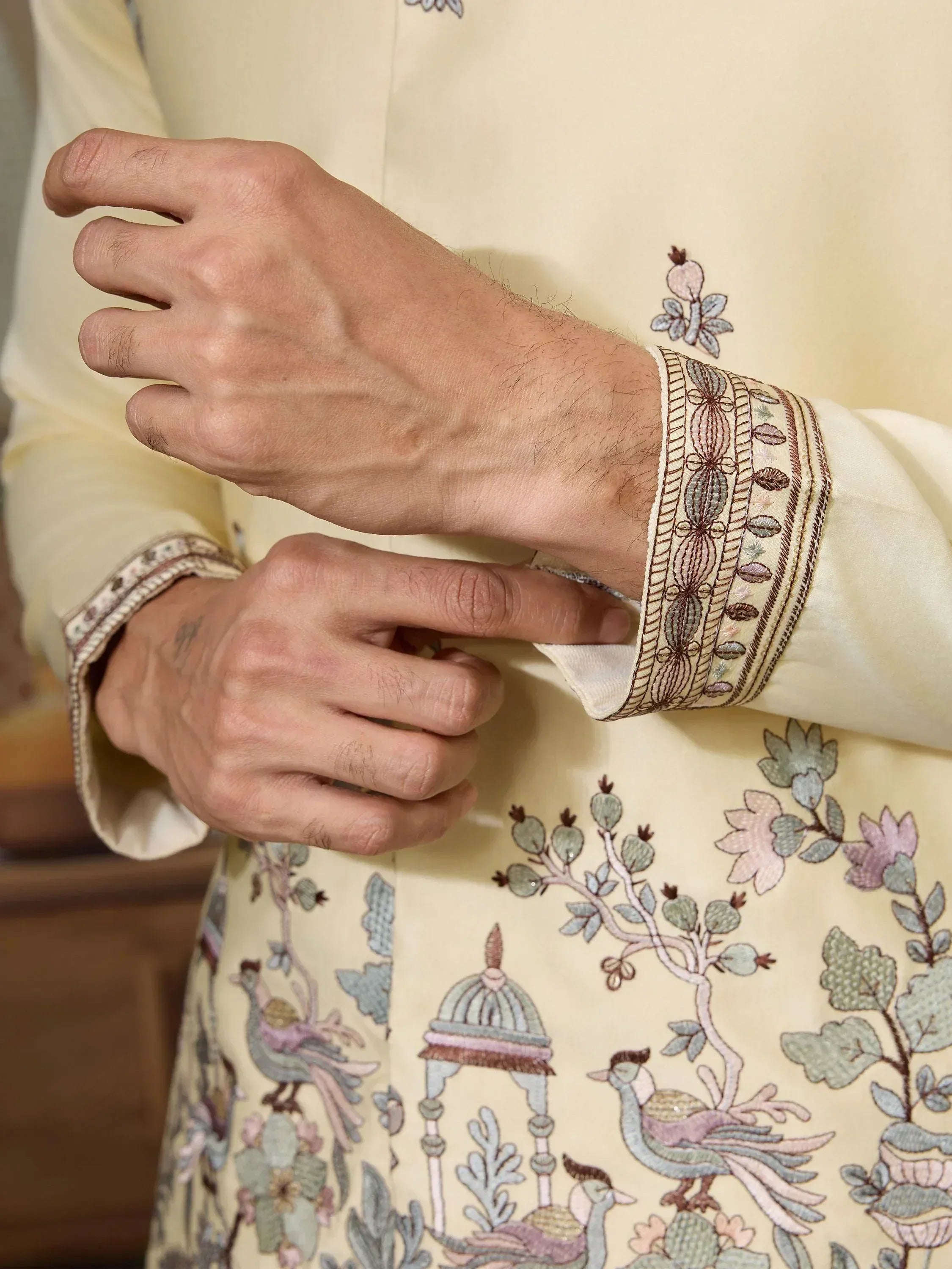 Cream embroidered kurta with floral and peacock motifs, detailed cuff design for men's ethnic wear
