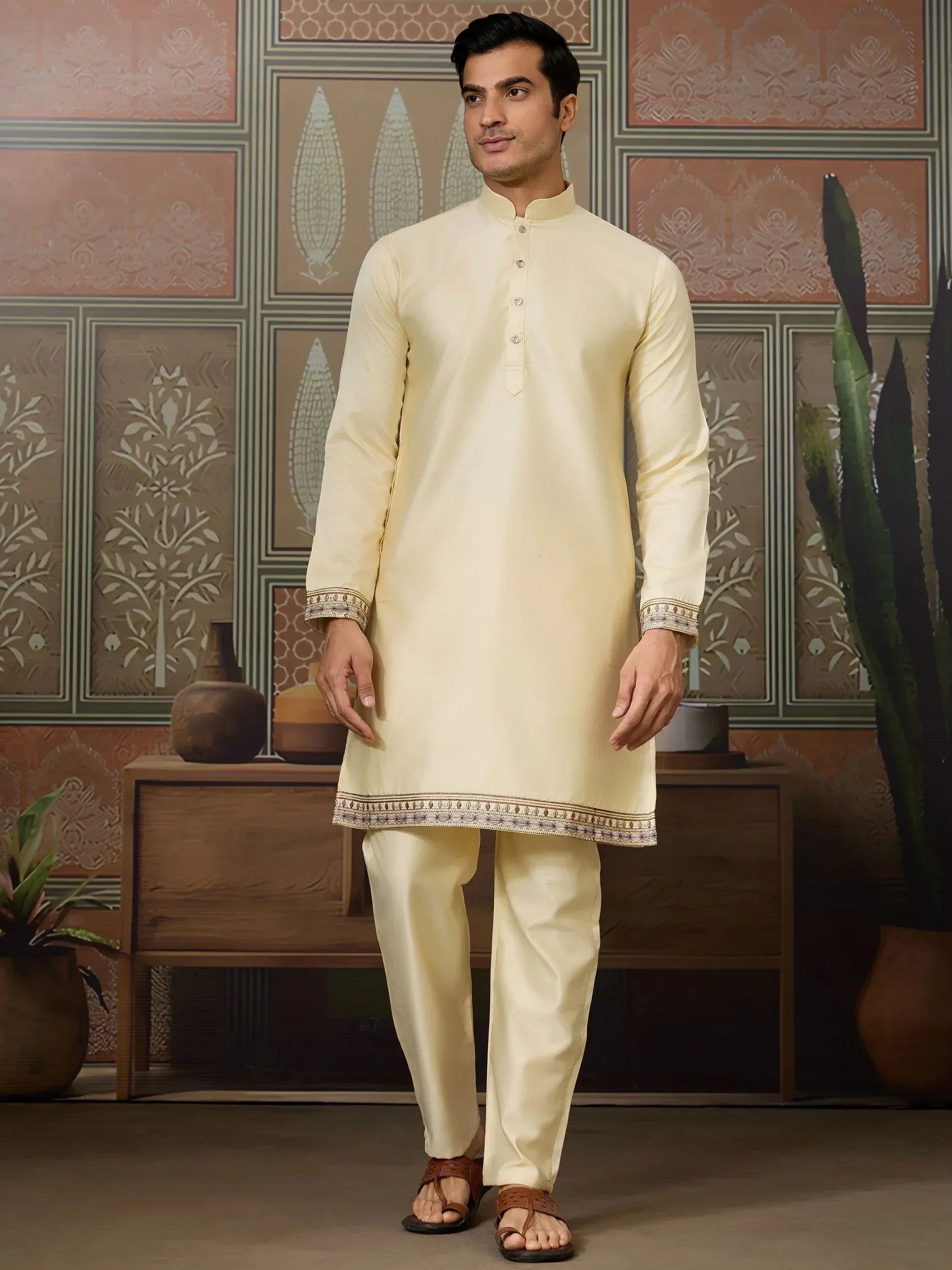 Men's cream ethnic kurta set with embroidered hem and cuffs, traditional Indian wear