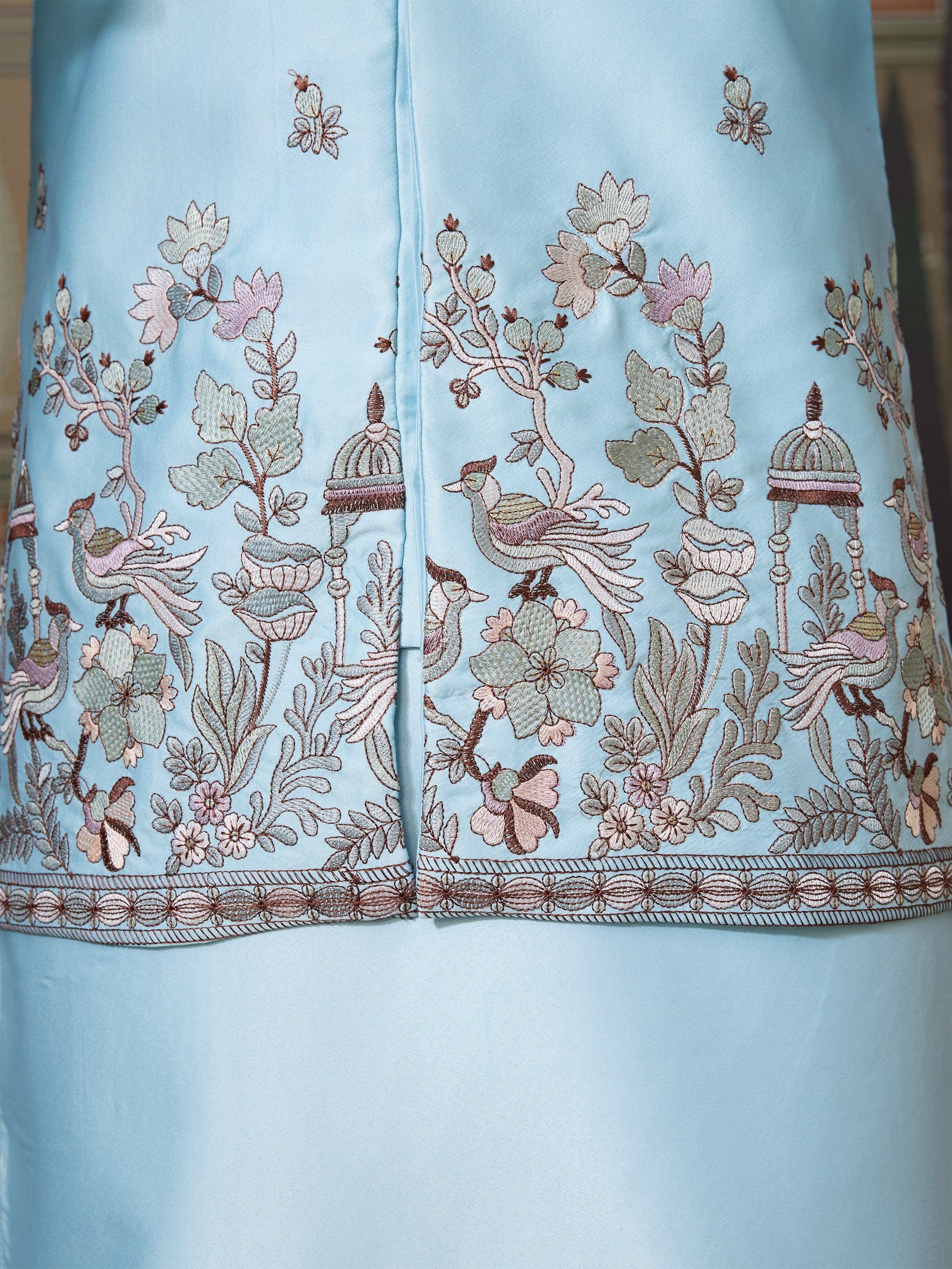 Light blue ethnic gown with intricate floral and bird embroidery, perfect for Indian occasions.
