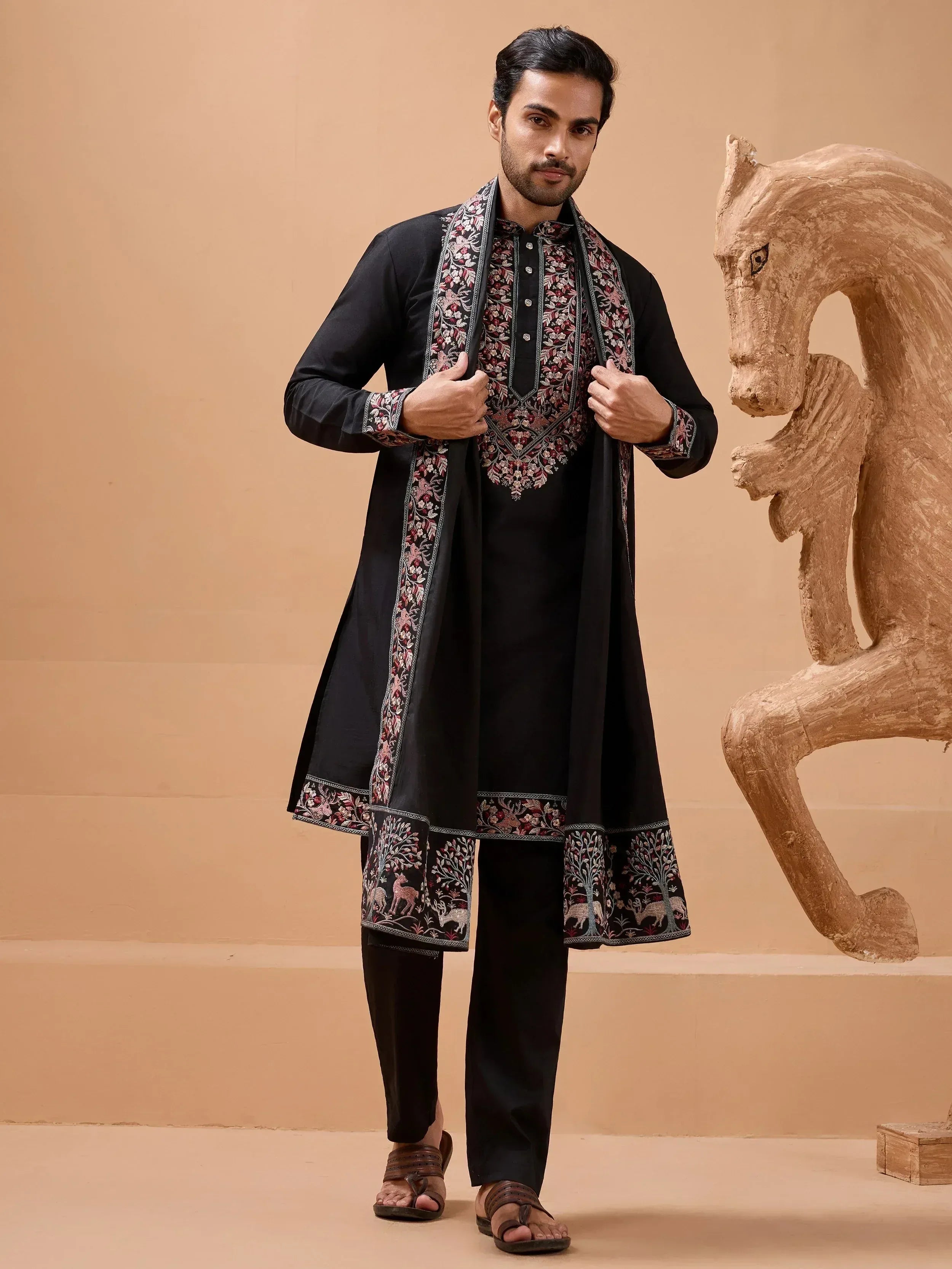 Man in black embroidered kurta set with floral and animal motifs, ethnic Indian wear