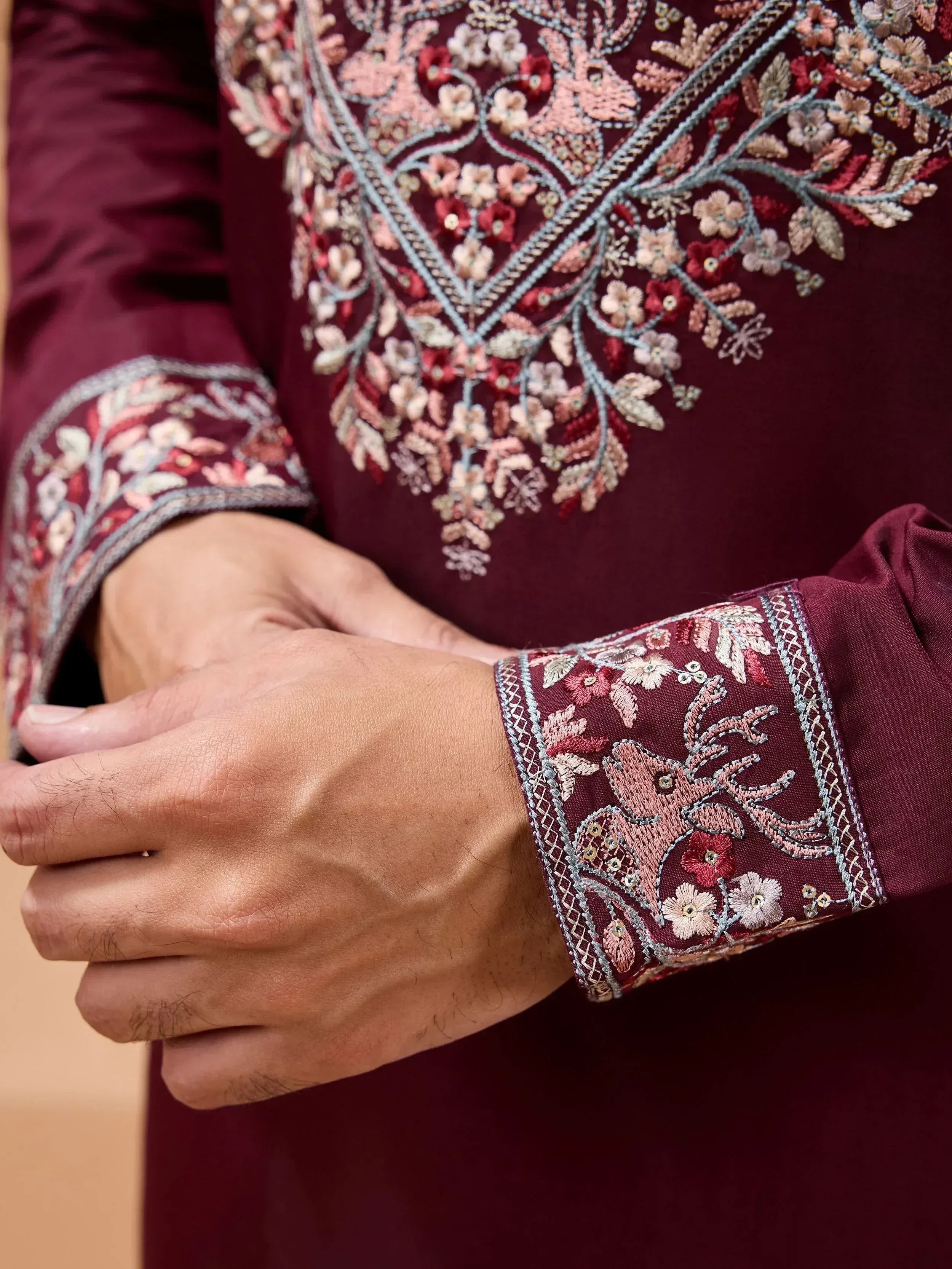 Maroon ethnic kurta with intricate floral embroidery and detailed cuffs, perfect for festive occasions.