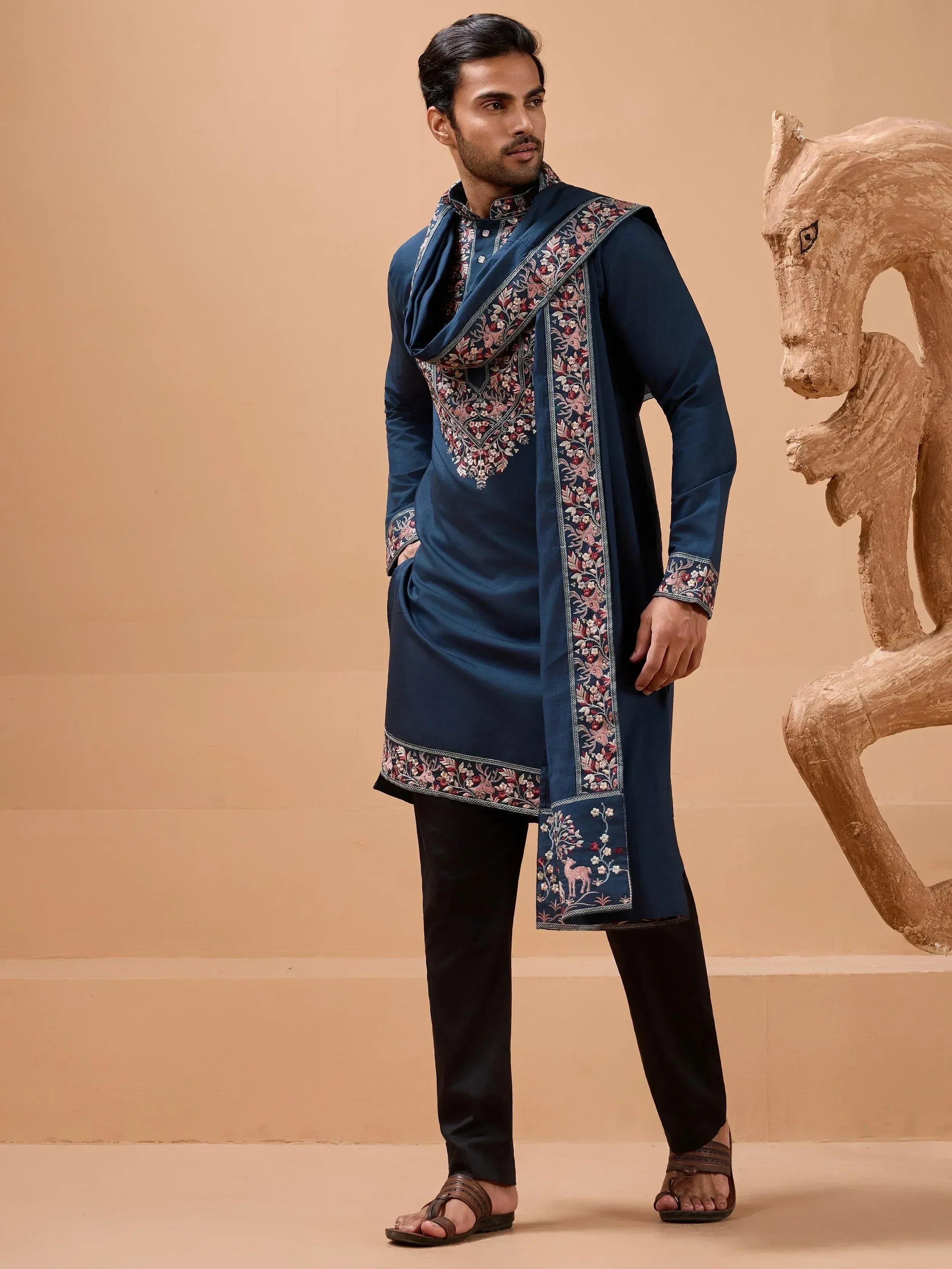 Navy blue embroidered kurta with floral and deer motifs, paired with black pants and matching stole for ethnic wear.