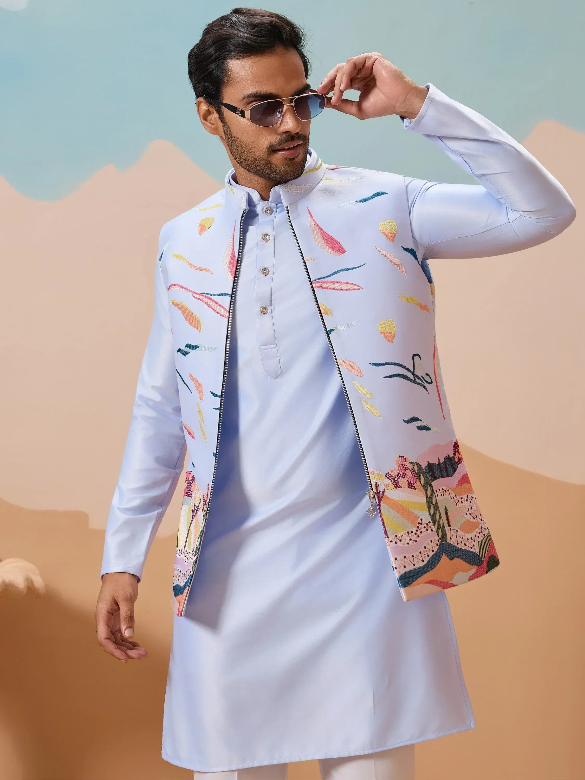 Man in light blue embroidered kurta with colorful abstract print, stylish ethnic wear for men
