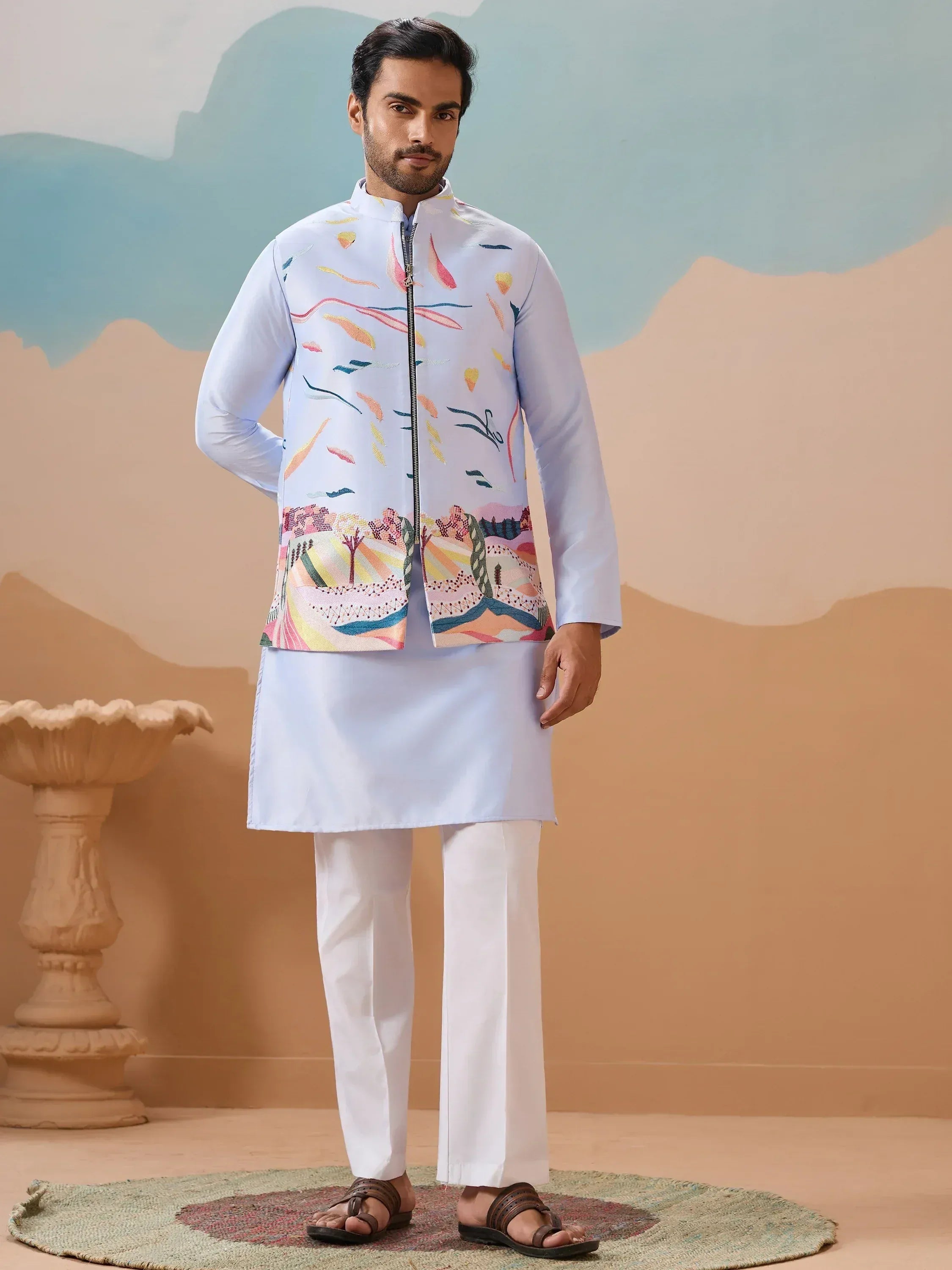 Man in light blue kurta set with colorful embroidered Nehru jacket, ideal for Indian ethnic occasions