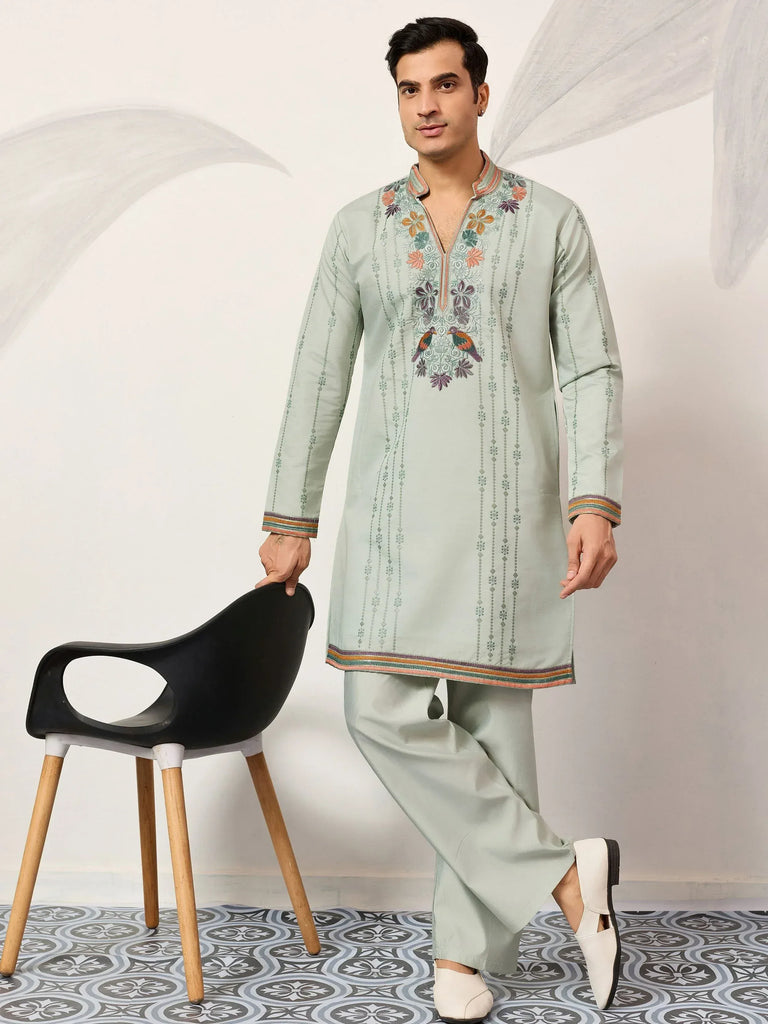 Mint green embroidered kurta pajama set with floral and bird motifs, perfect for festive occasions.