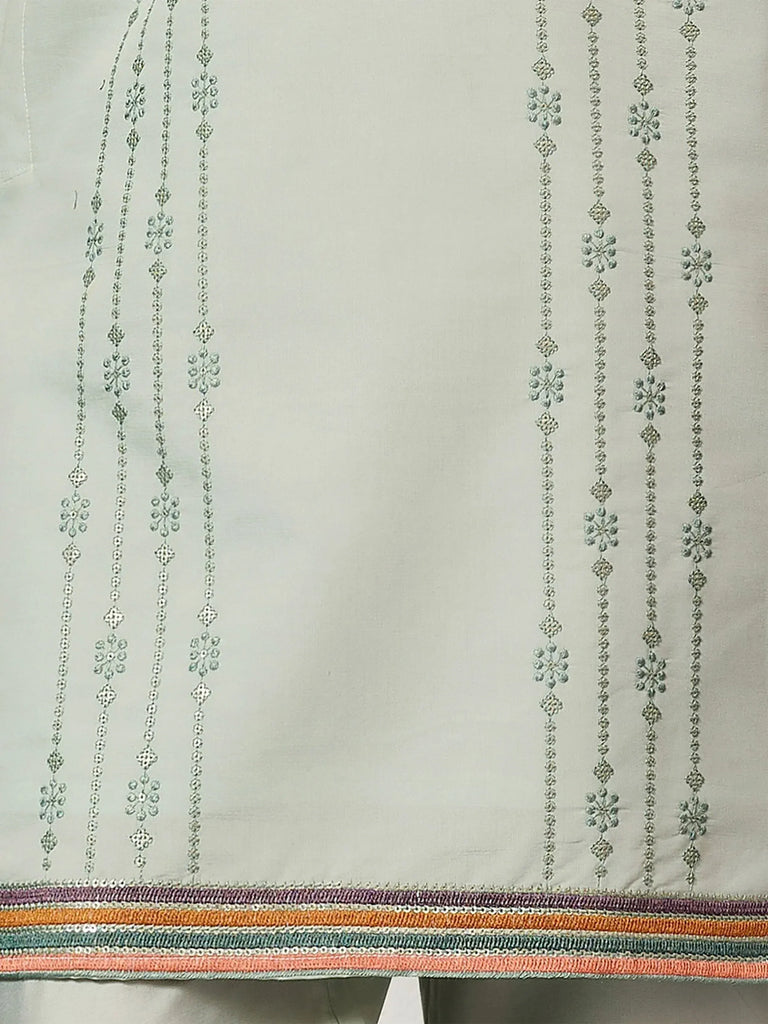 Elegant ethnic wear with intricate floral embroidery and colorful border detailing
