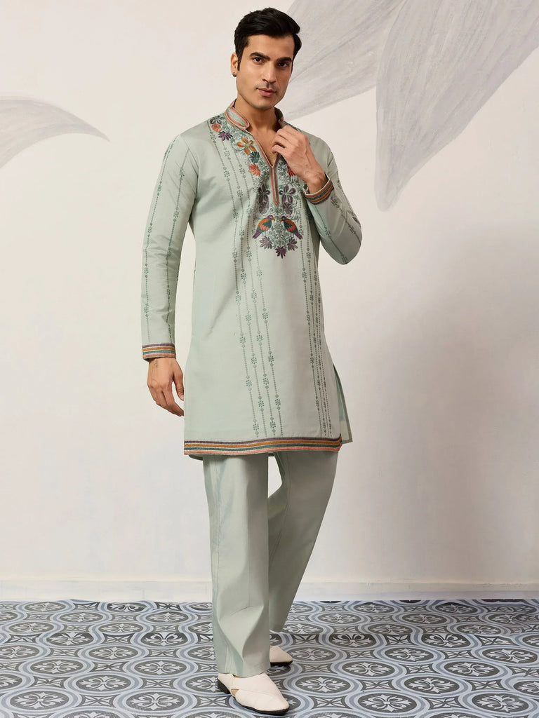 Mint green embroidered kurta pajama set with floral and bird motifs, perfect for Indian ethnic occasions.