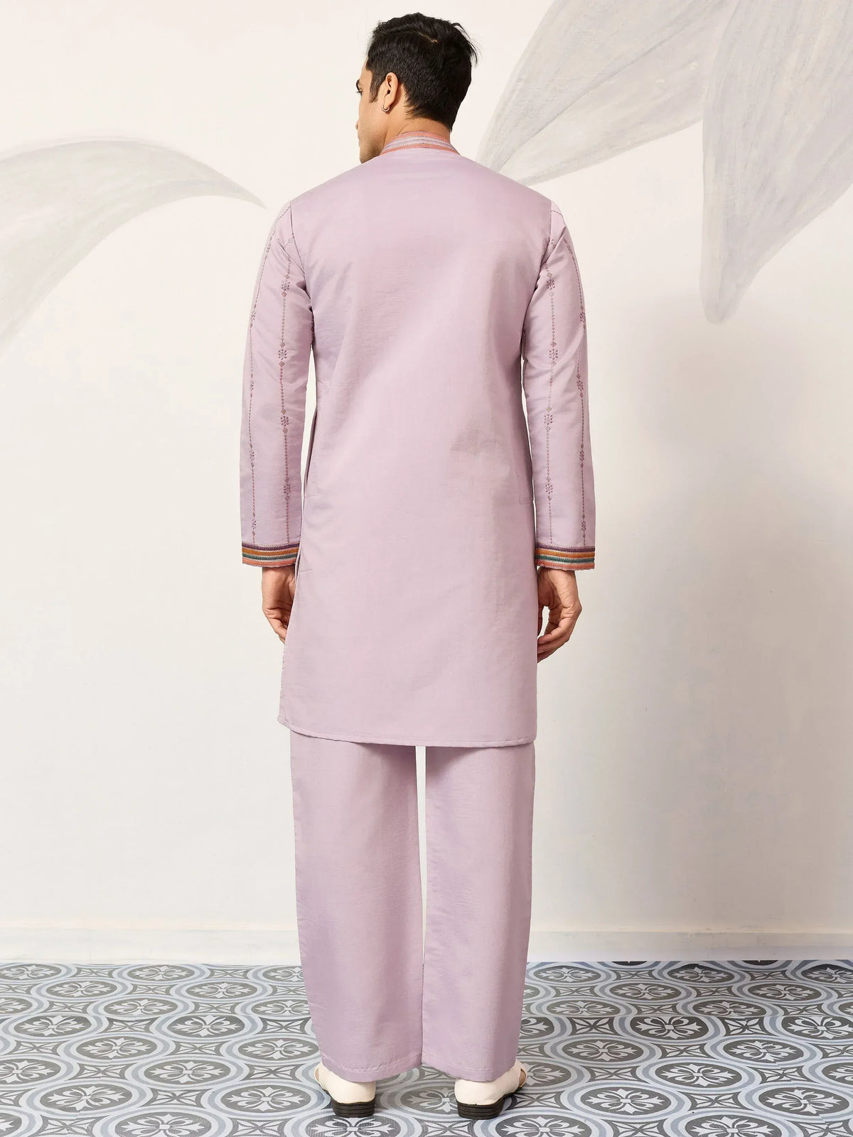 Men's light purple kurta set with embroidered sleeves and colorful trim, ideal for ethnic occasions.